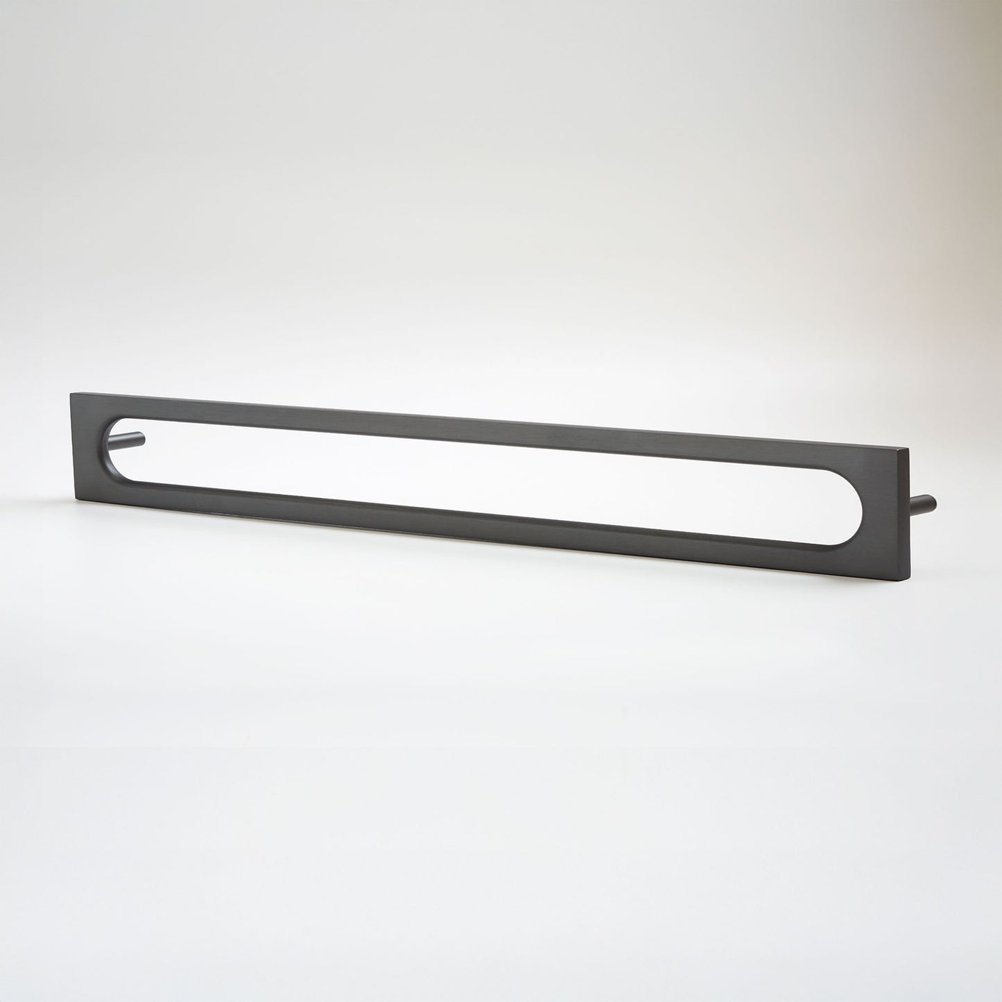 A matte black metal cabinet pull with an elongated oval cutout in the center, shown on a clean white studio background.
