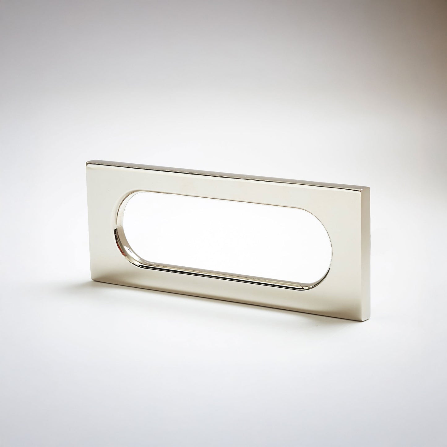 A modern rectangular pull handle with an oval cutout, finished in a brushed silver metal, shown on a light gray gradient background.