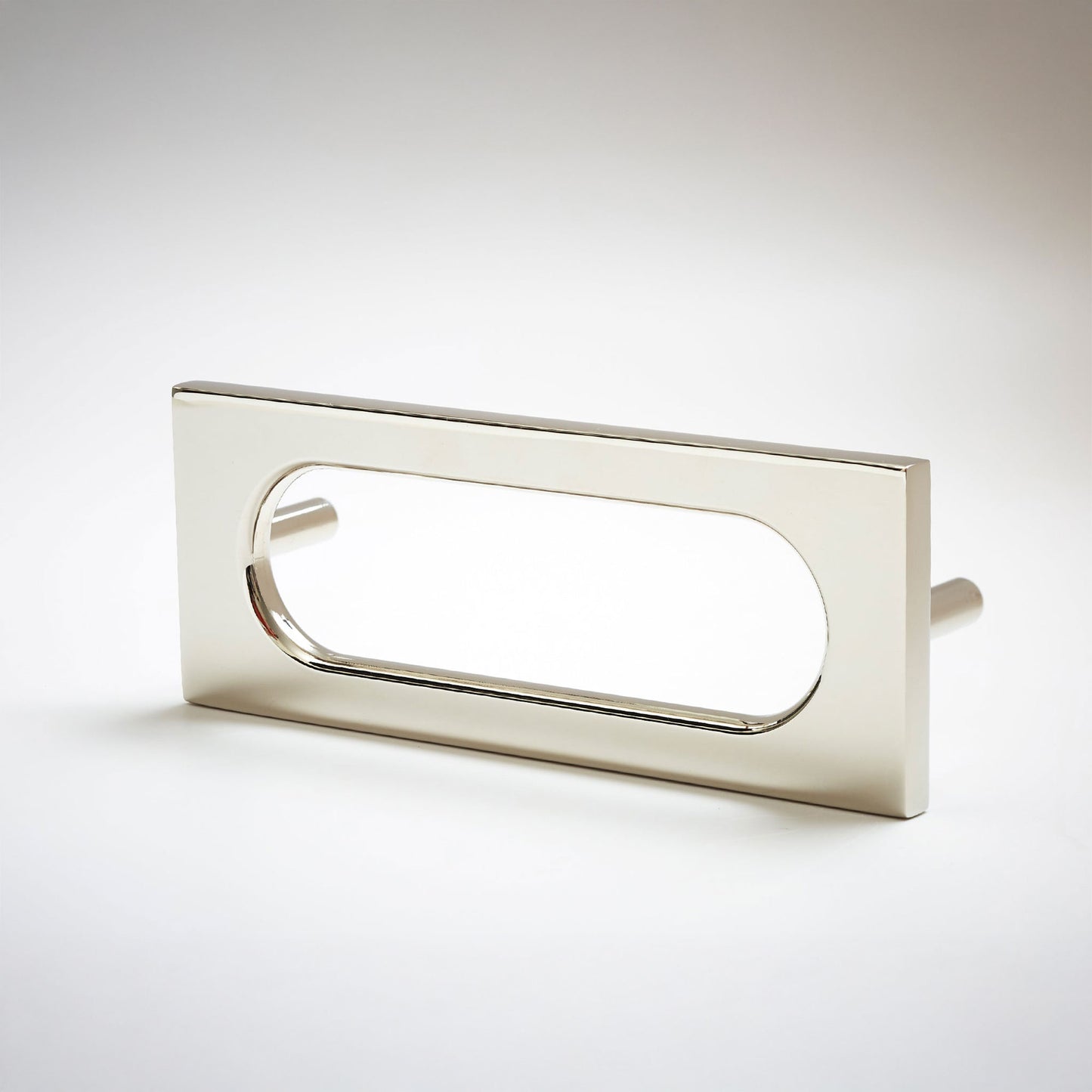 A modern rectangular pull handle with a polished silver finish and an oval cutout, shown on a clean light gray background.