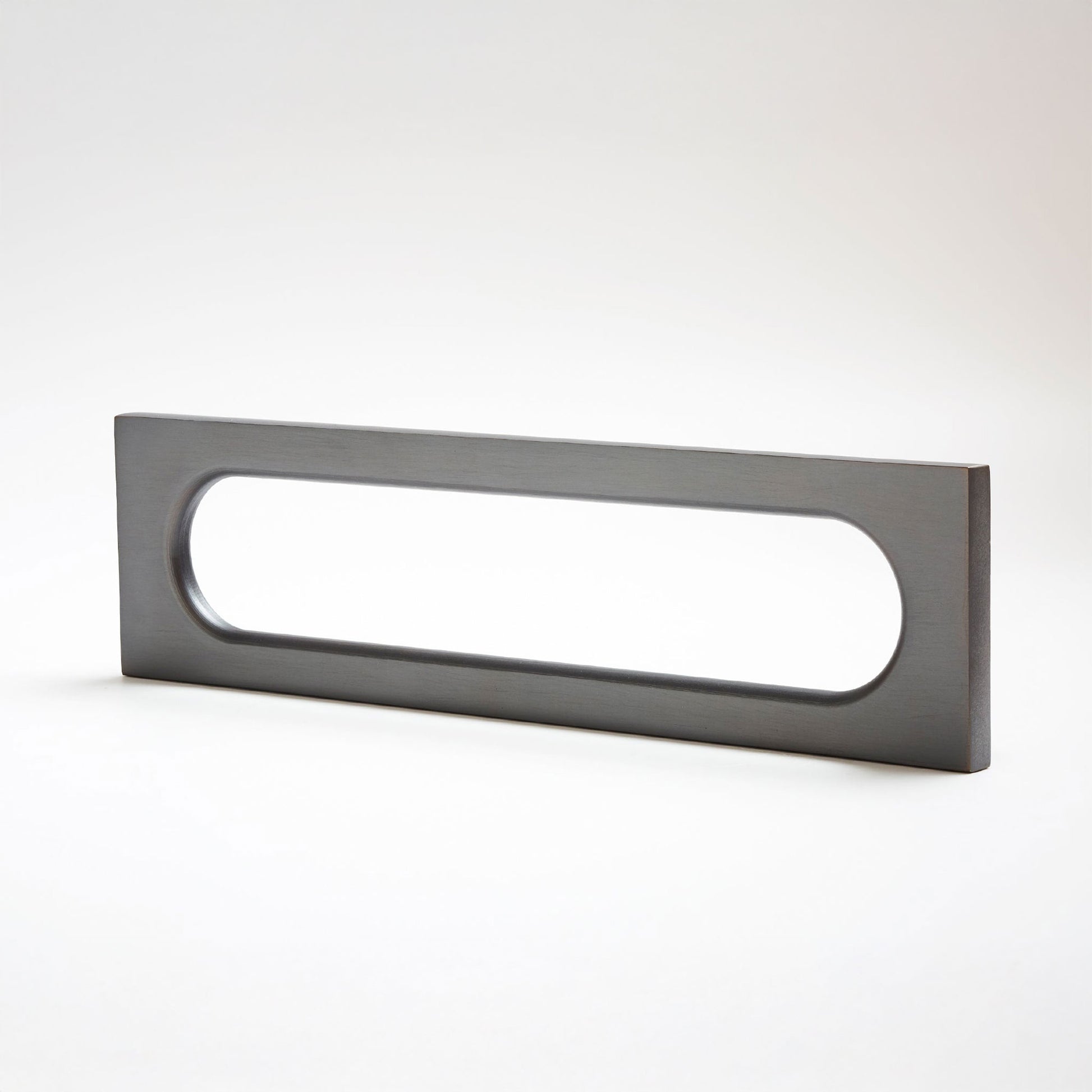 A modern rectangular door pull handle with an elongated oval cutout, finished in a matte dark gray metal, shown on a clean white background.