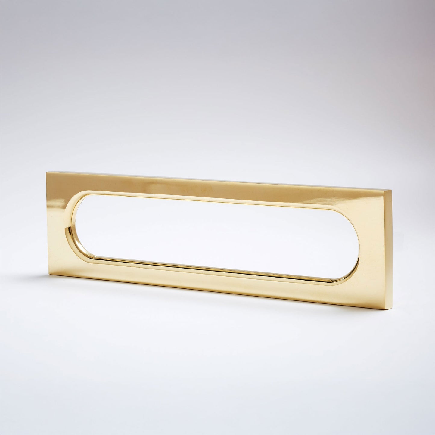 A modern rectangular pull handle with a polished gold finish and an oval cutout, shown on a clean light gray gradient background.