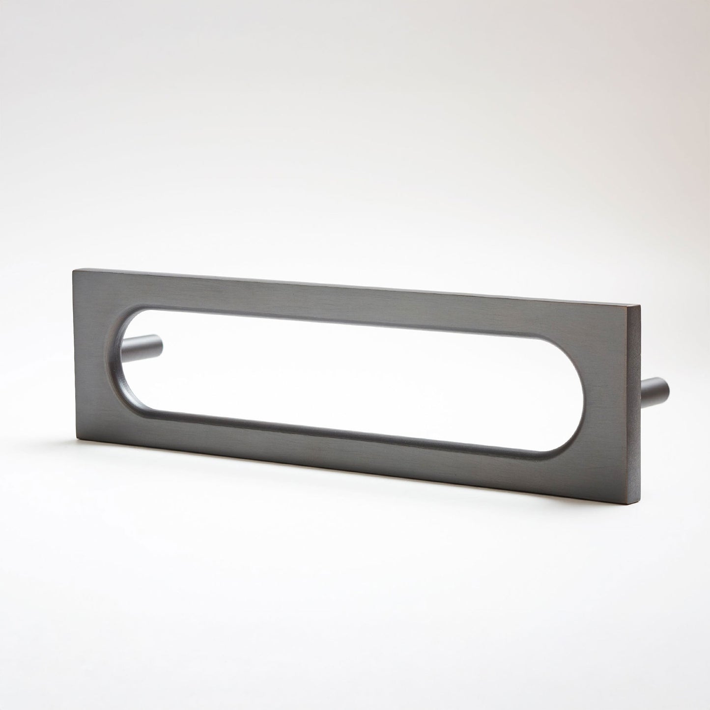 A modern rectangular pull handle with an elongated oval cutout, finished in a matte dark gray metal, shown on a clean white background.