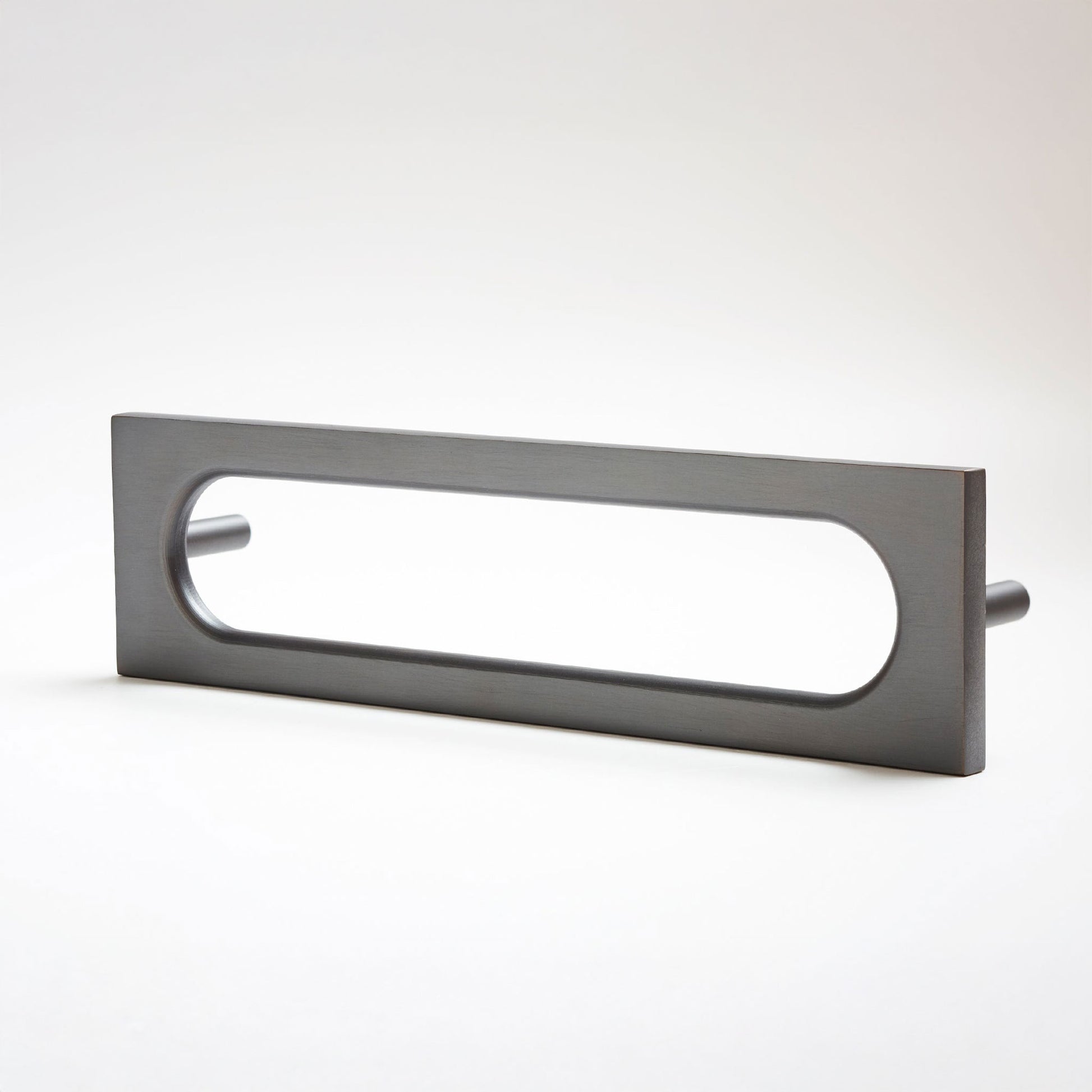 A modern rectangular pull handle with an elongated oval cutout, finished in a matte dark gray metal, shown on a clean white background.