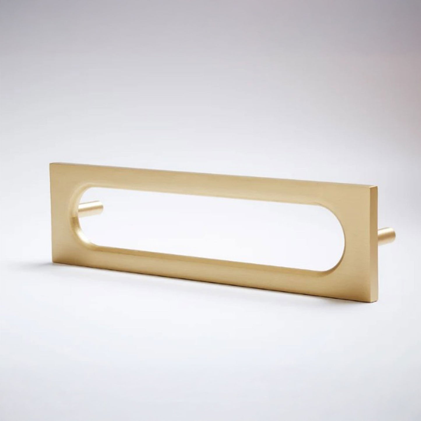 A modern rectangular door pull handle with an elongated oval cutout, finished in a brushed gold metal, shown on a clean light gray background.