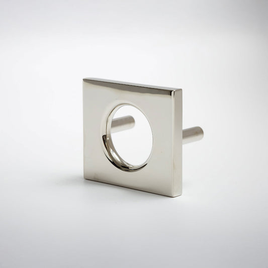 A modern square metal cabinet pull with a circular cutout in the center, shown on a clean light gray background.