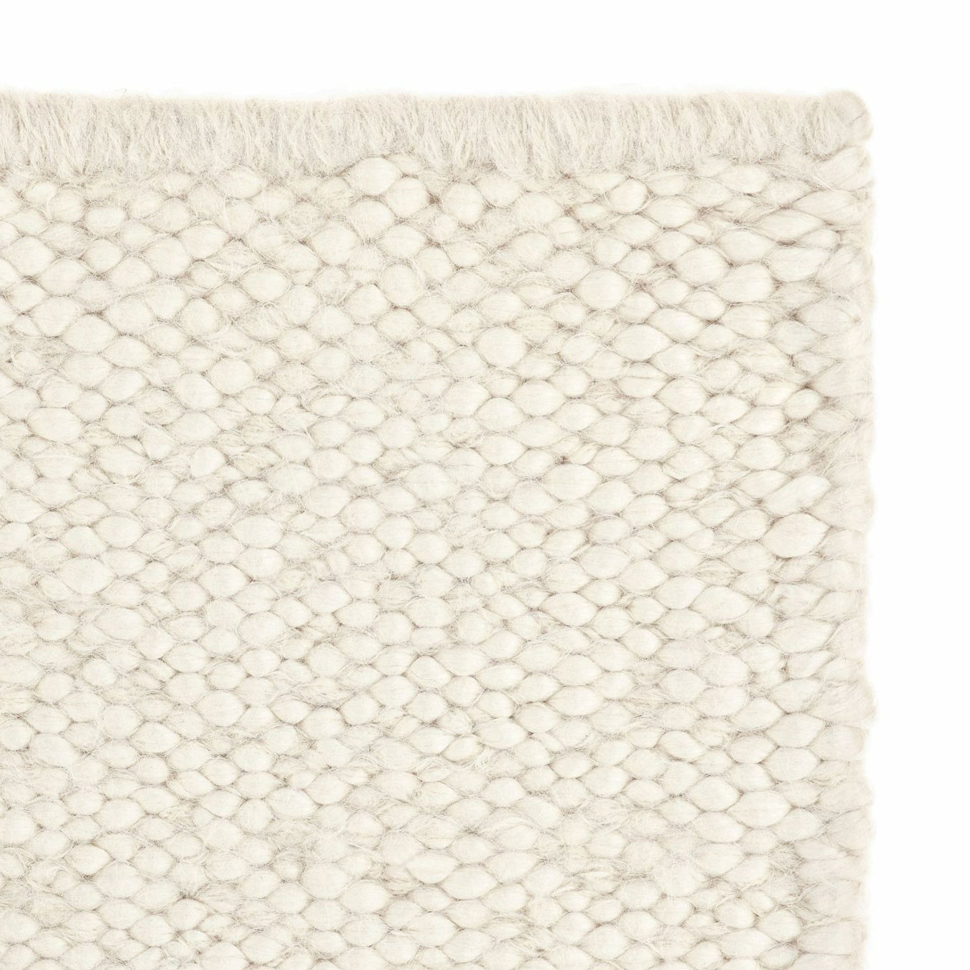 Neve rug style in cream colored mottled heavy flat weave