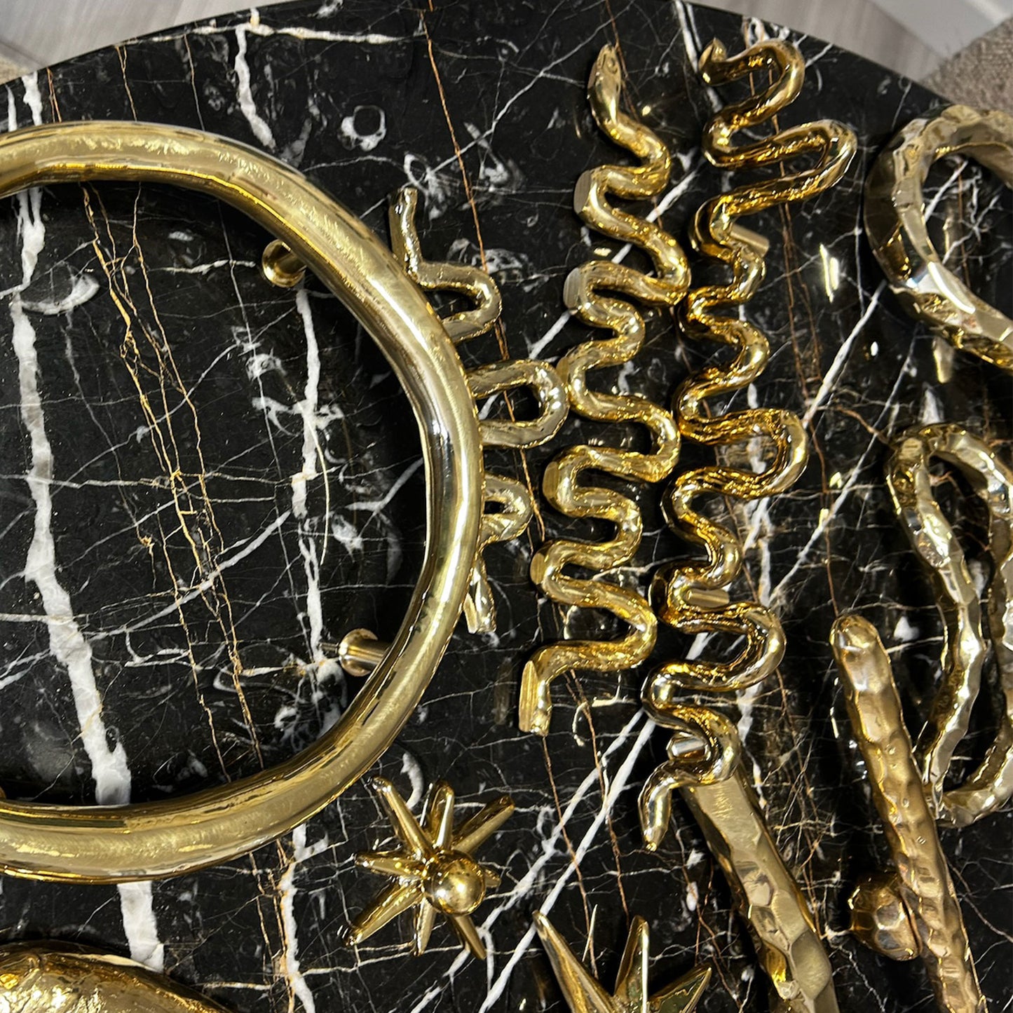 Brass decorative cabinet pulls on a black marble backround