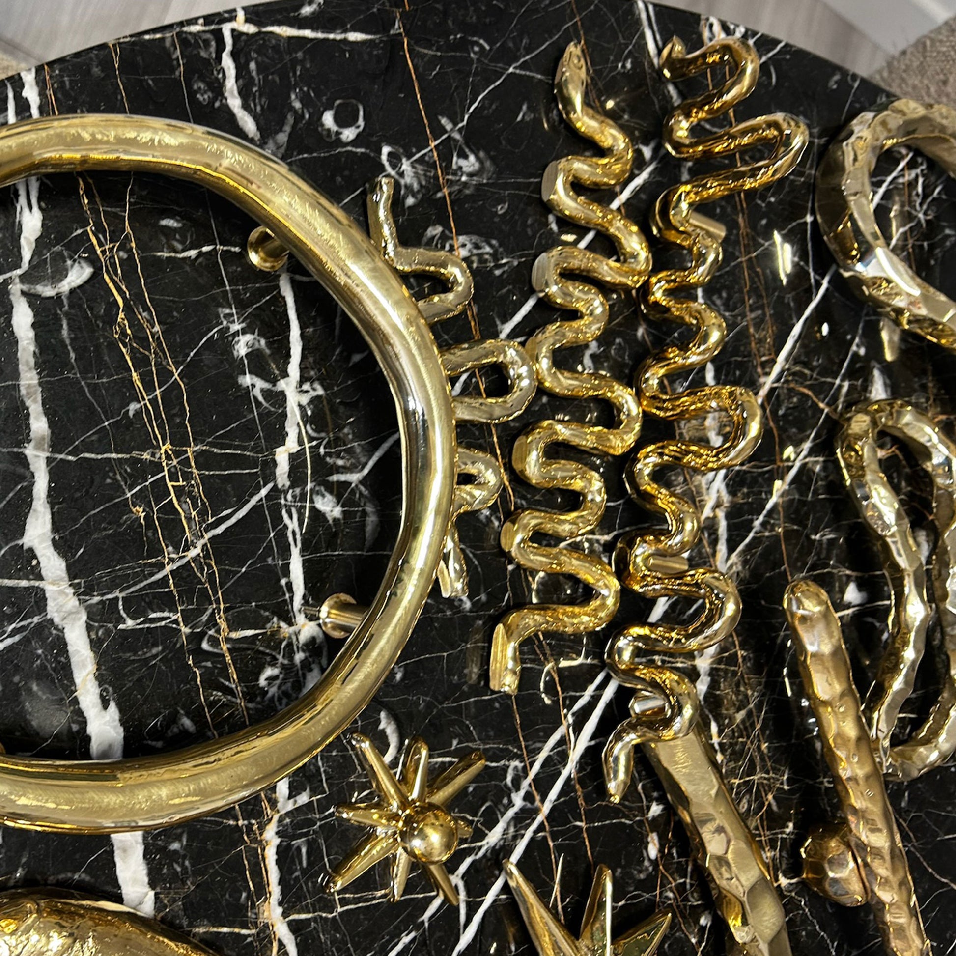 Brass decorative cabinet pulls on a black marble backround