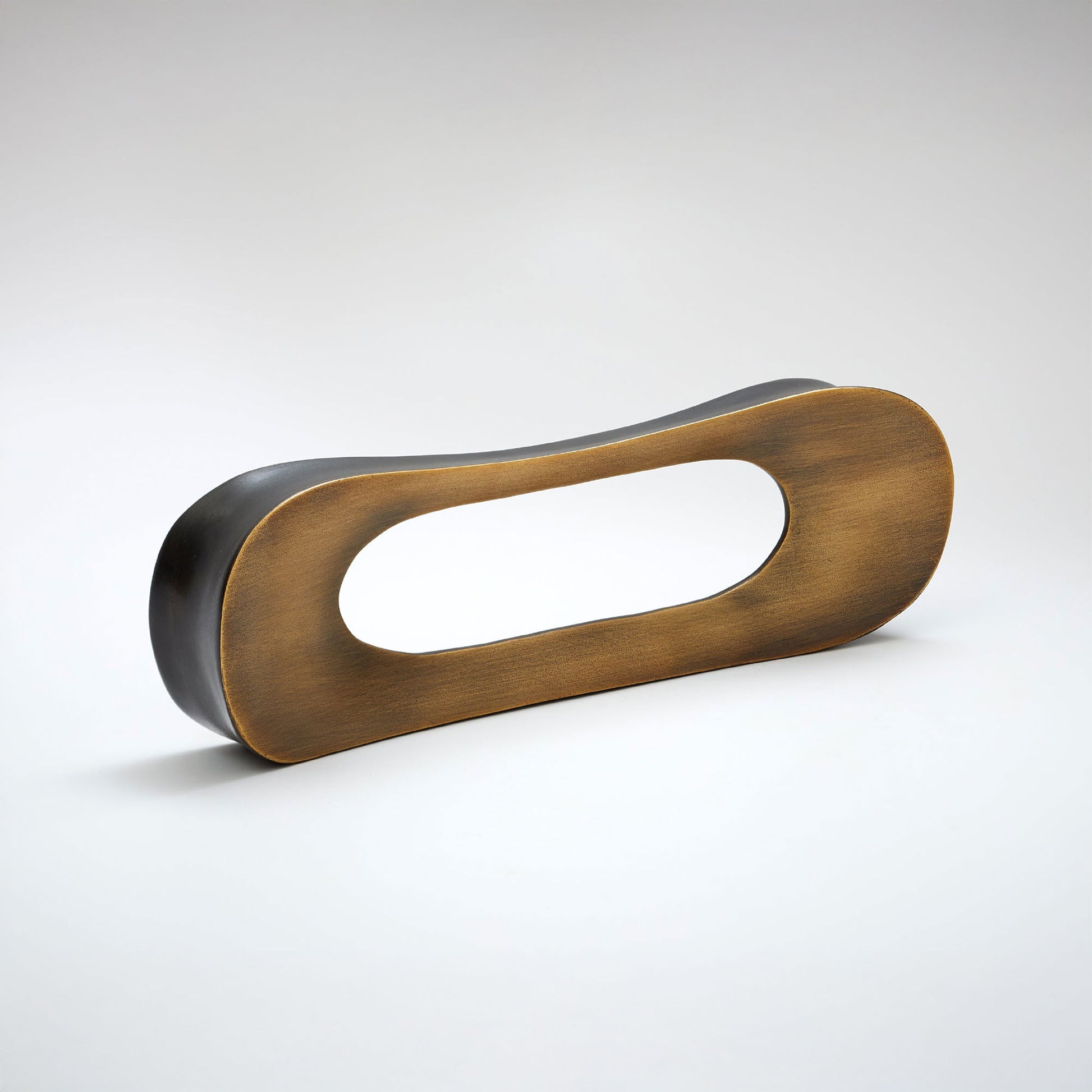 A modern minimalist cabinet pullt with a brushed bronze-brown metallic frame and a matte black backing, photographed on a clean light gray studio background.