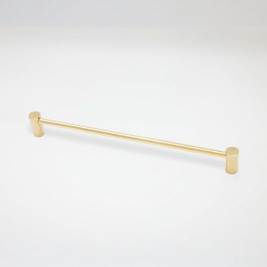 A modern cabinet pull with a brushed gold finish, featuring cylindrical end caps, shown against a plain white background.