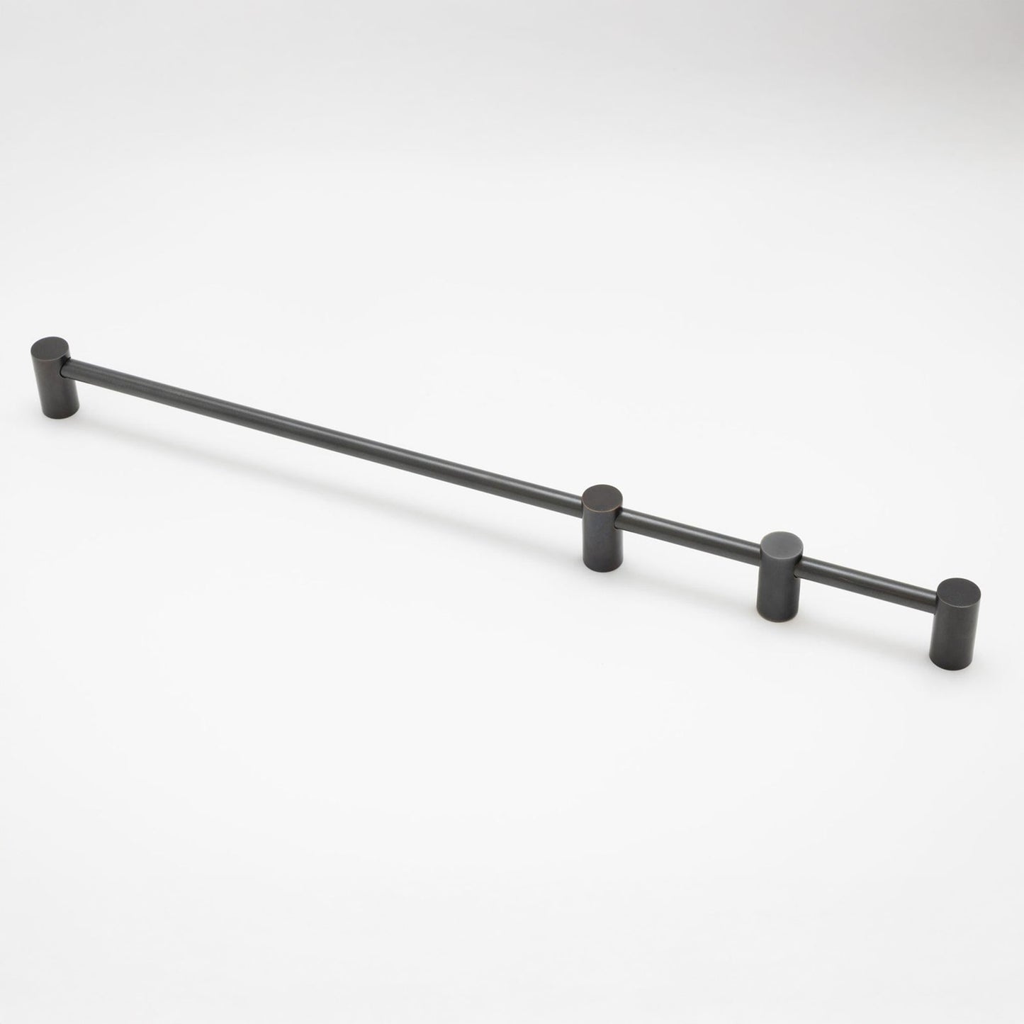 A matte black metal cabinet pull with cylindrical end caps and three mounting posts, shown on a clean white background.