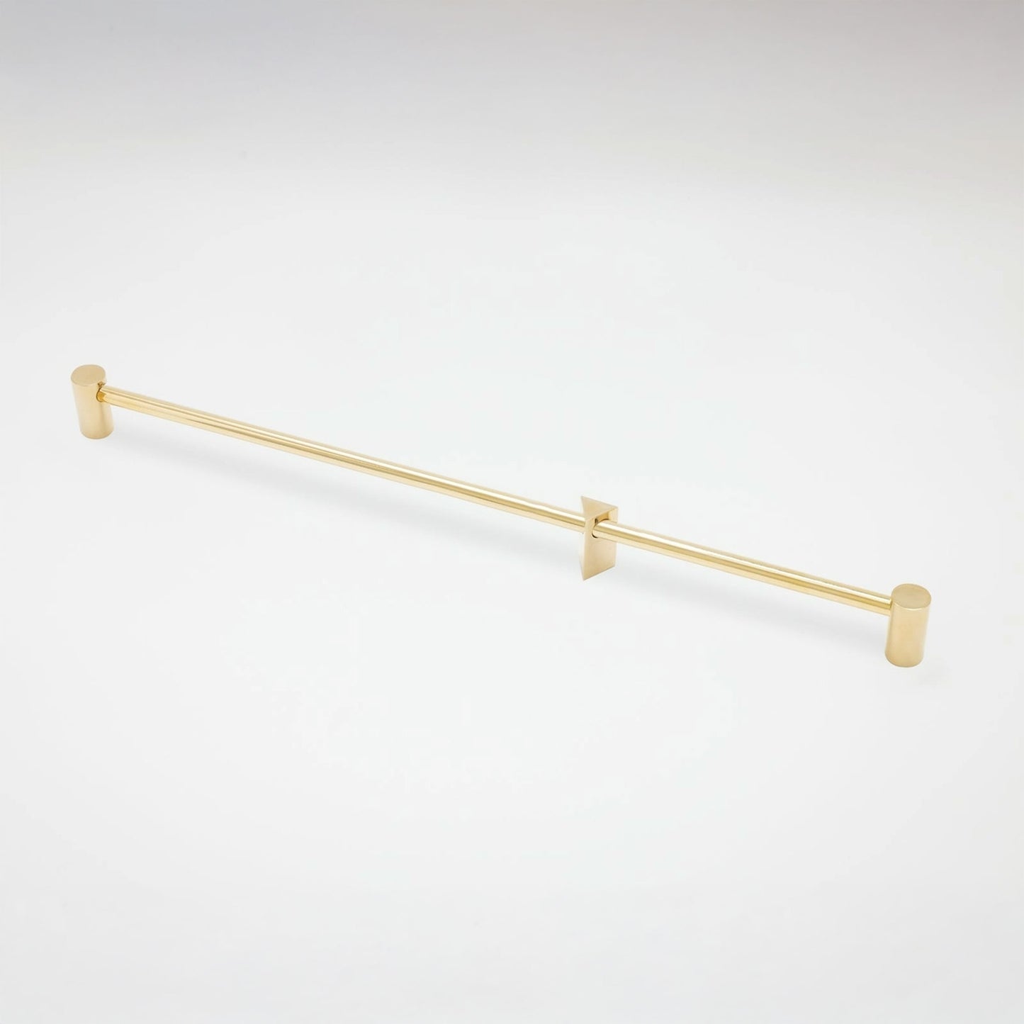 A slim gold metal cabinet pull with cylindrical end caps and two triangular wall mounts, shown on a clean white background.