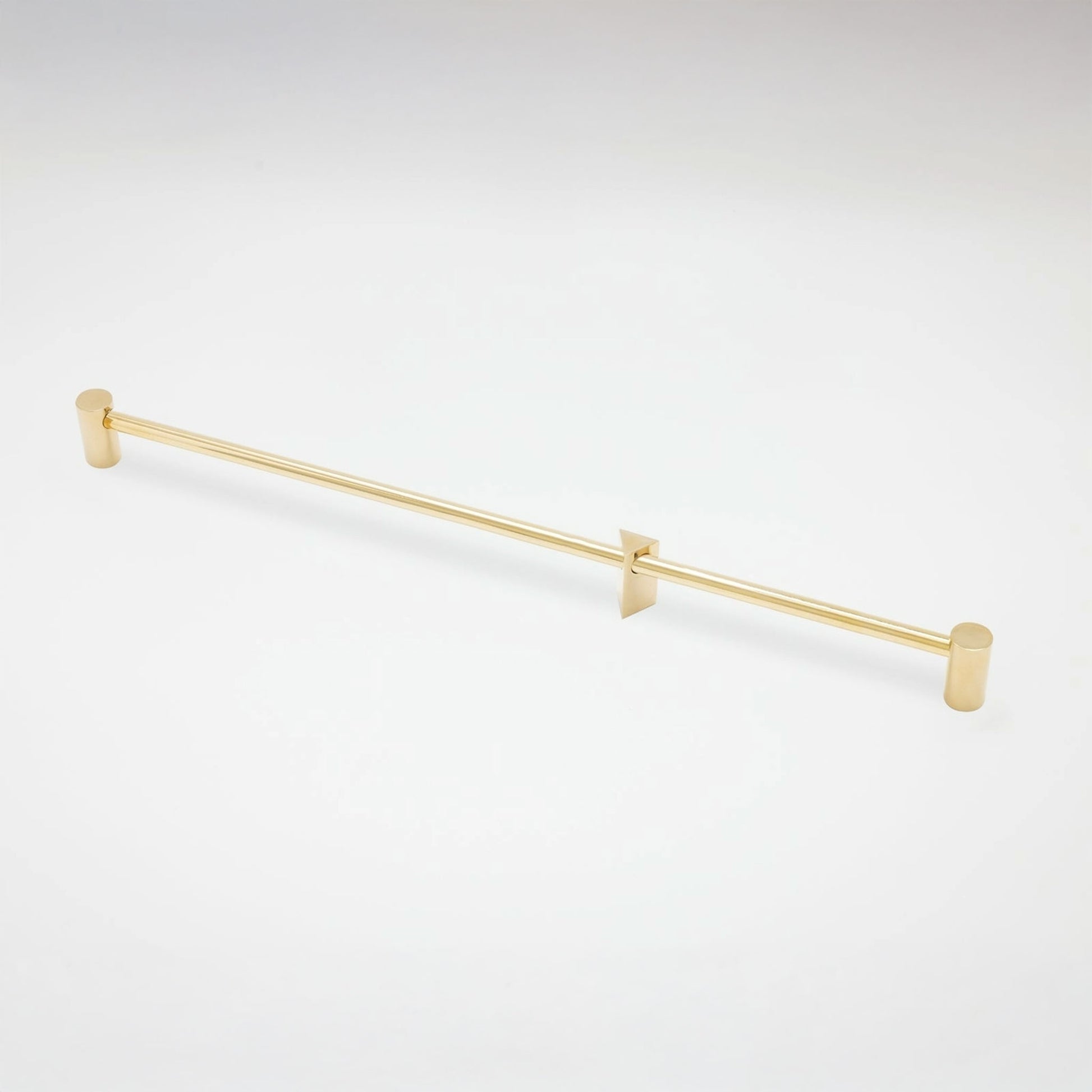 A slim gold metal cabinet pull with cylindrical end caps and two triangular wall mounts, shown on a clean white background.
