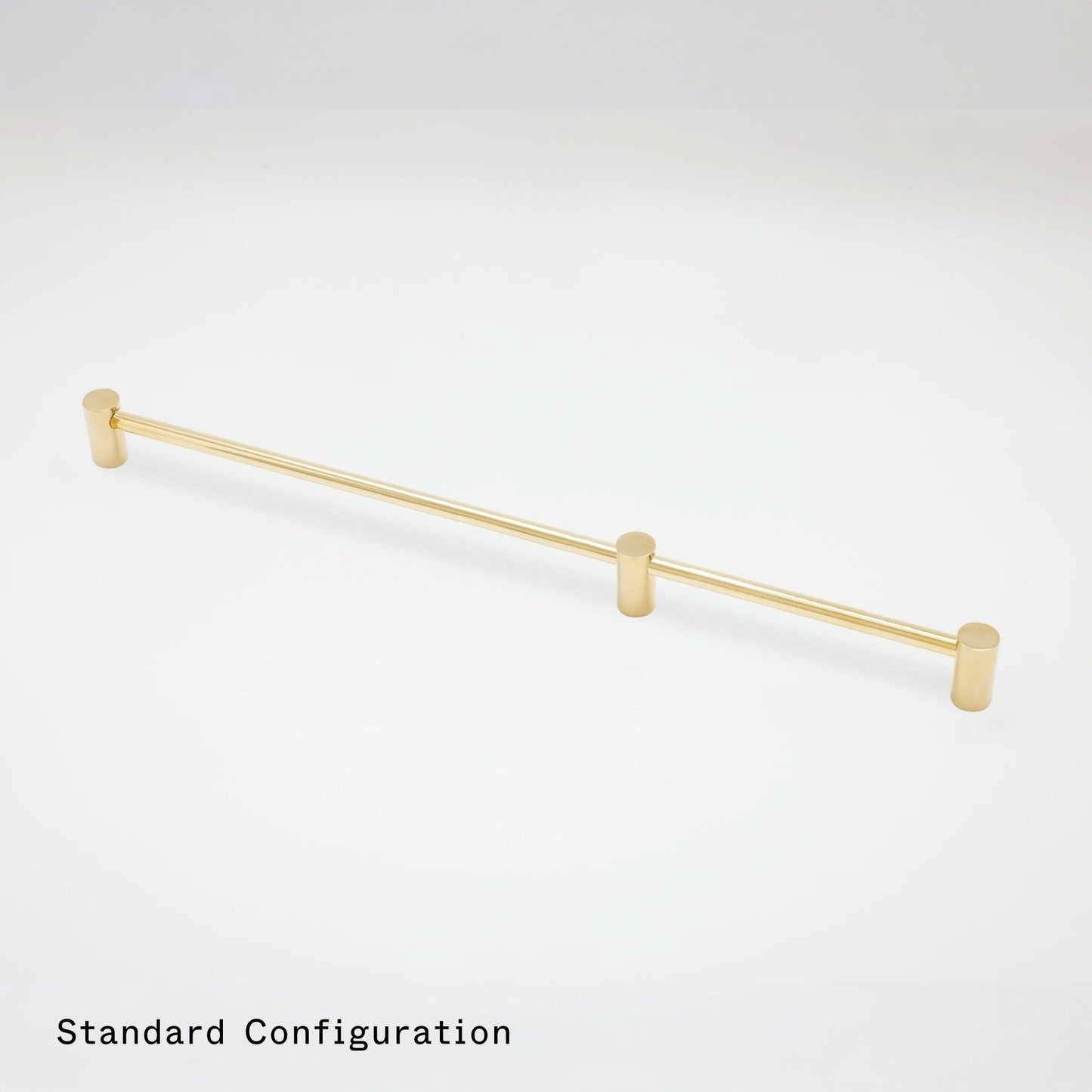 A long, slim gold cabinet pull with cylindrical end caps and two small vertical posts, shown on a clean white background with the text 'Standard Configuration' in the lower left.