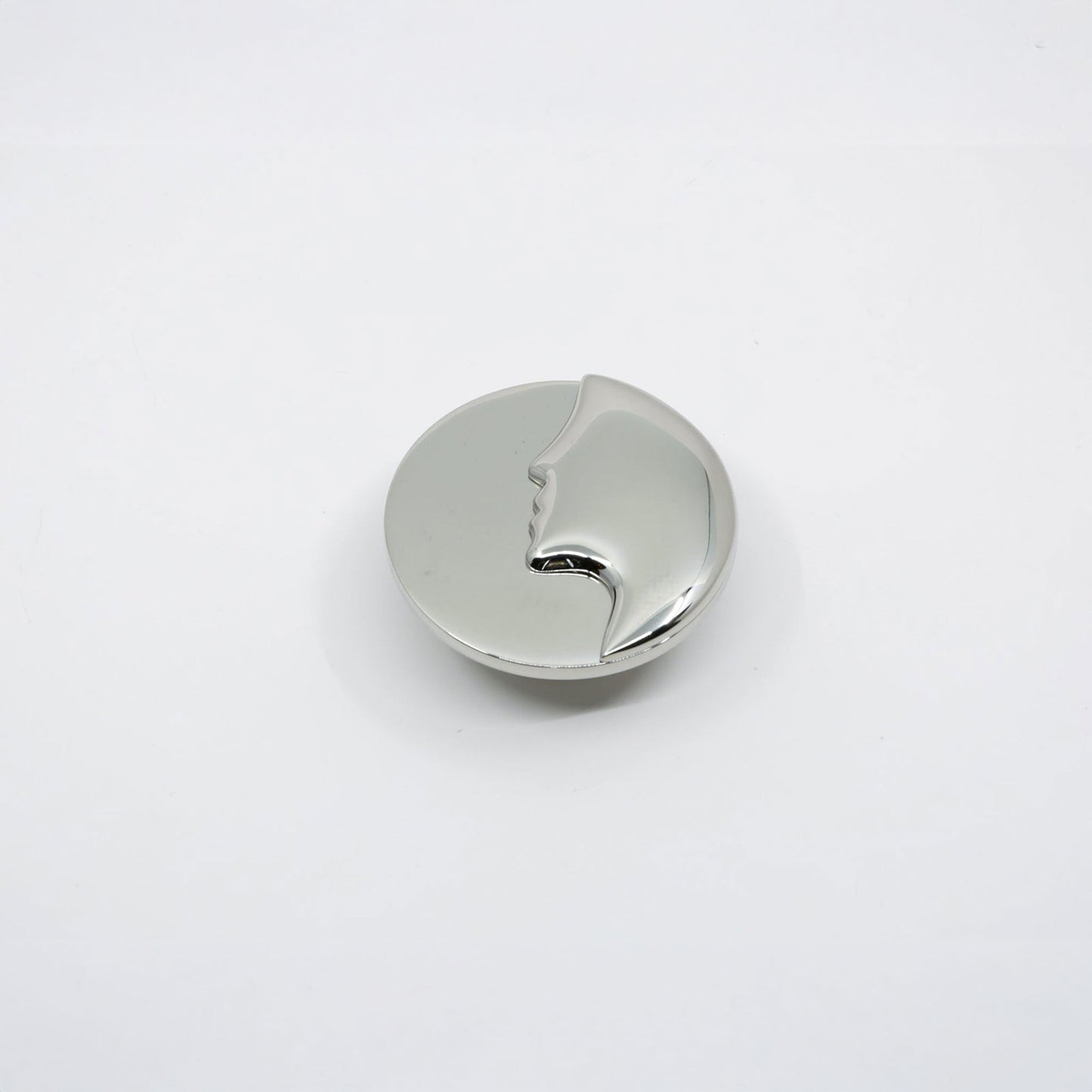 A polished silver metal cabinet knob with a small cutout detail, shown on a plain white background.