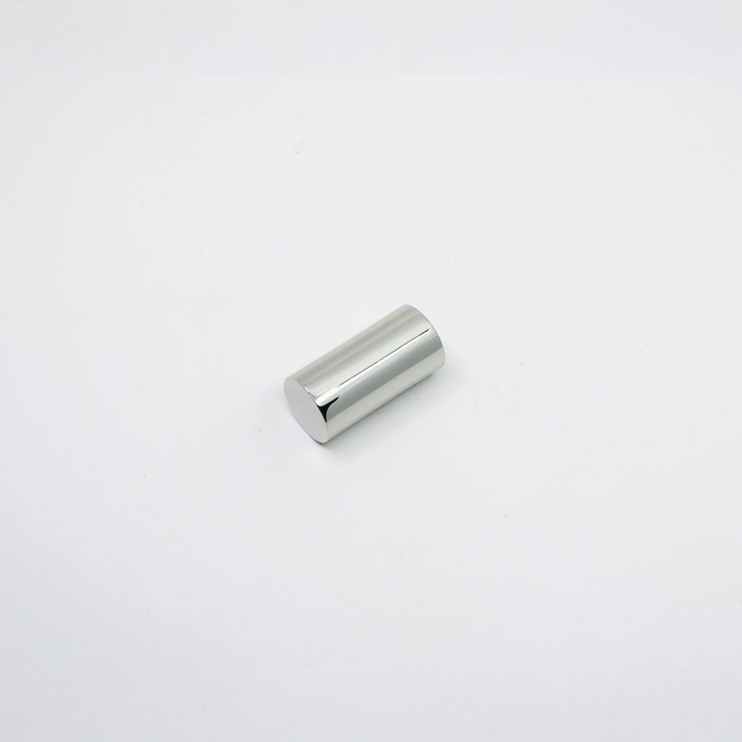 A small cylindrical metallic knob with a polished silver finish, photographed on a seamless white background.