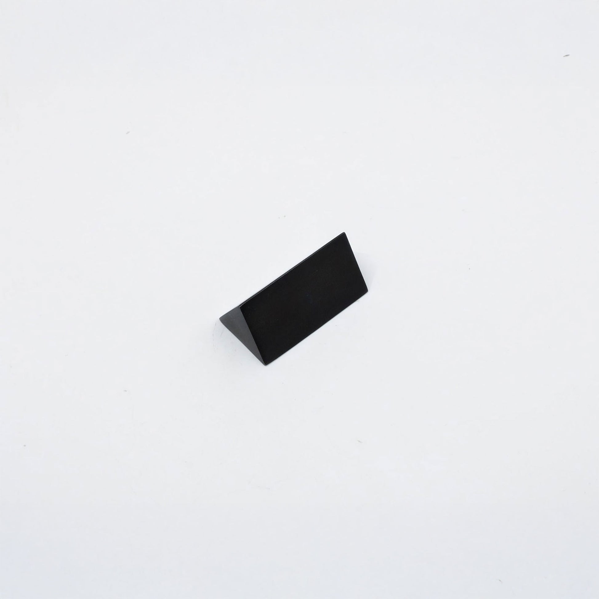 A small black triangular metal r decorative knob, shown on a plain white background.