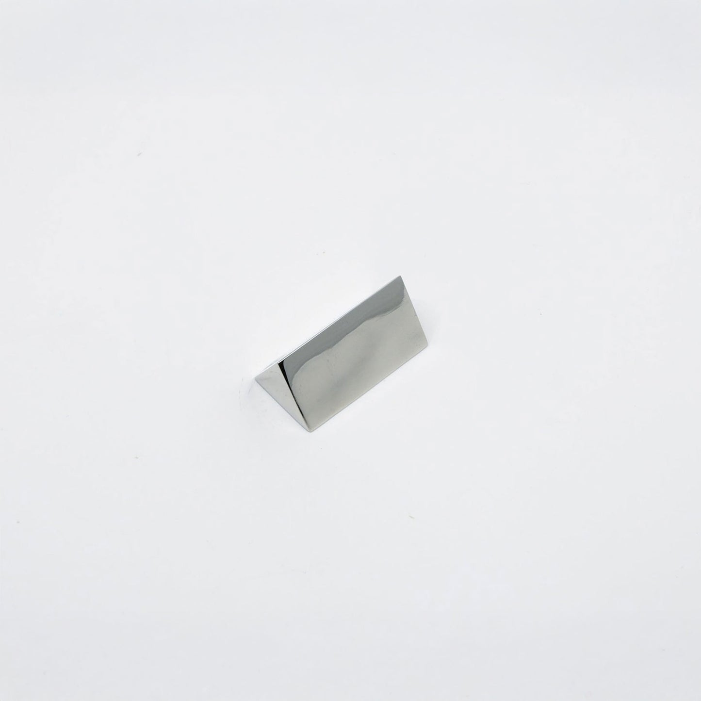 A small polished metallic triangular metal r decorative knob, shown on a plain white background.