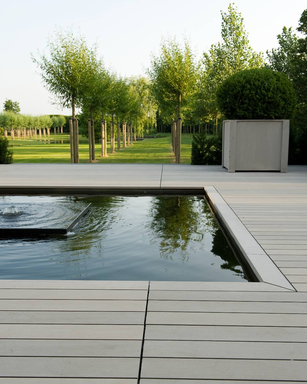 A classic modern water feature with bubbler fountain surrounded by Esthec decking.