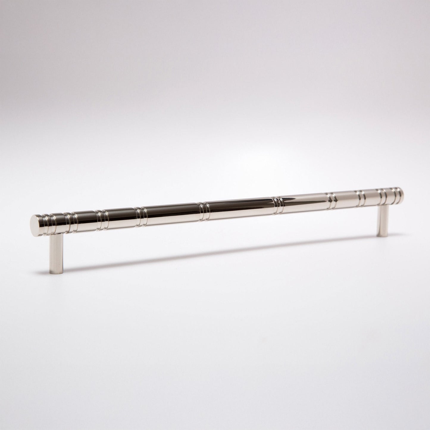 A polished silver metal cabinet pull handle with a textured, segmented grip design, shown on a clean white studio background.