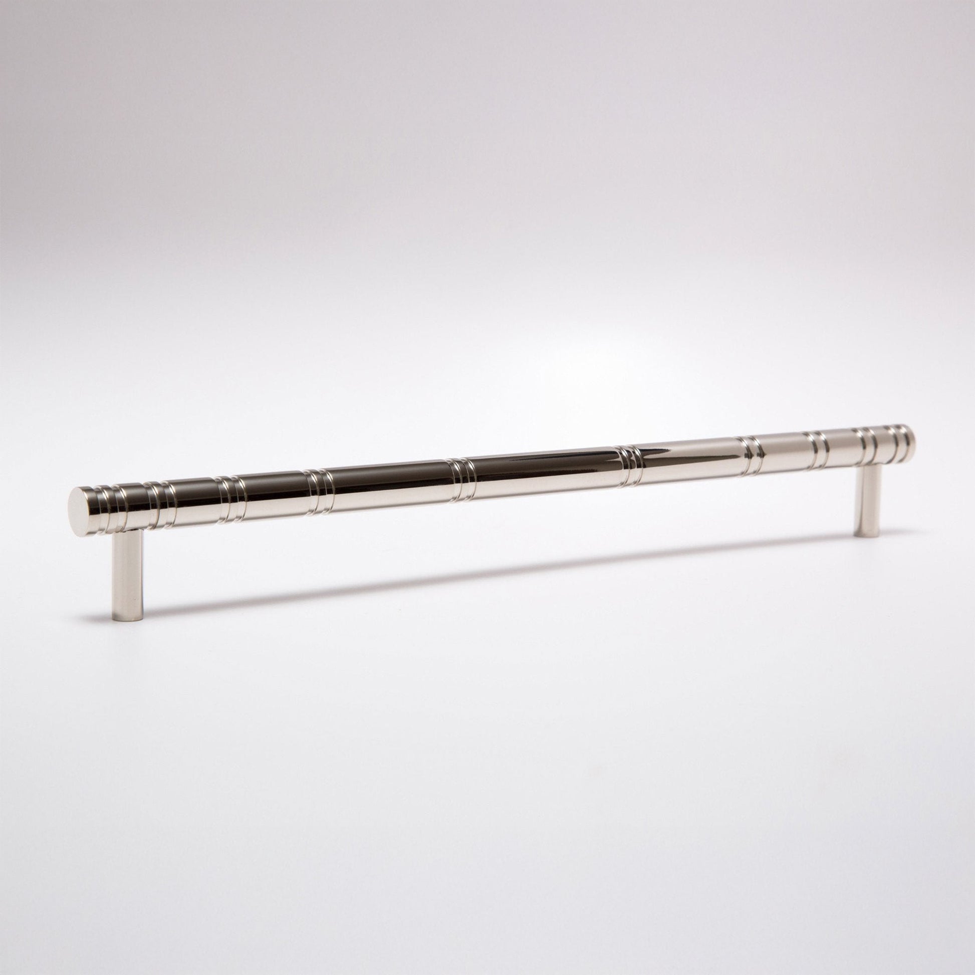 A polished silver metal cabinet pull handle with a textured, segmented grip design, shown on a clean white studio background.