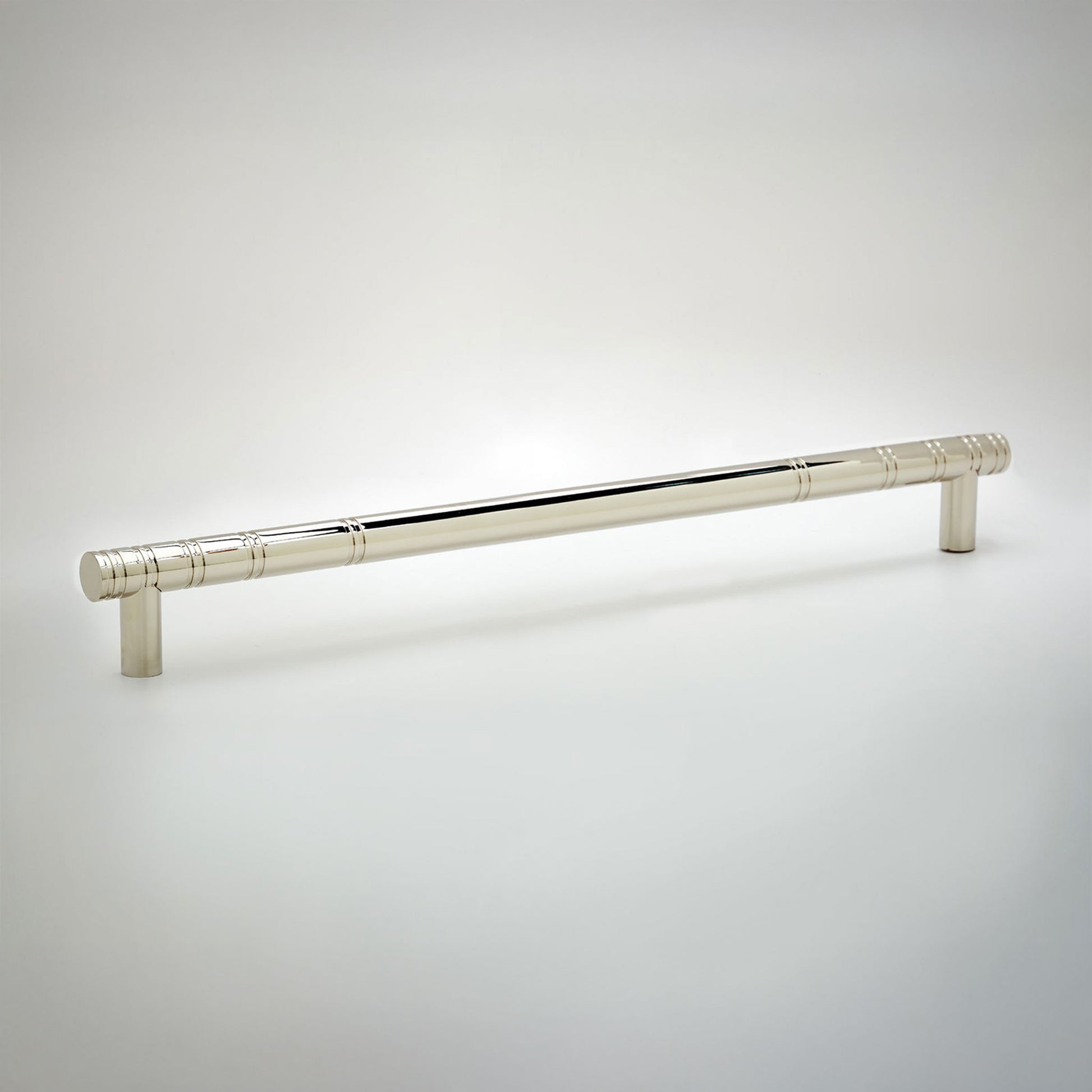 A polished silver cabinet pull handle with a cylindrical rod and decorative knurled ends, shown on a light gray gradient background.