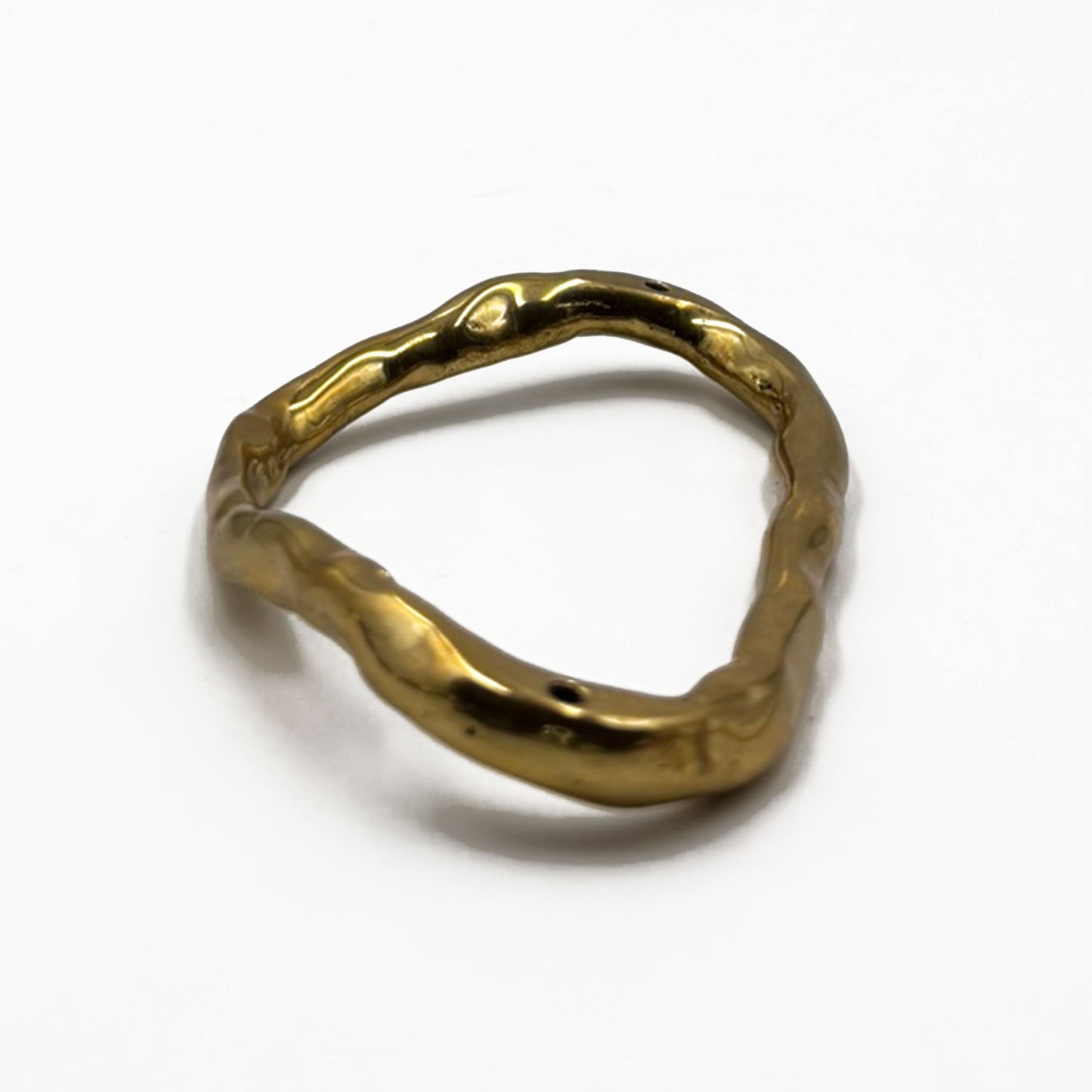 Polished Unlacquered Brass organic shaped ring  cabinet pull with a textured design on a white background