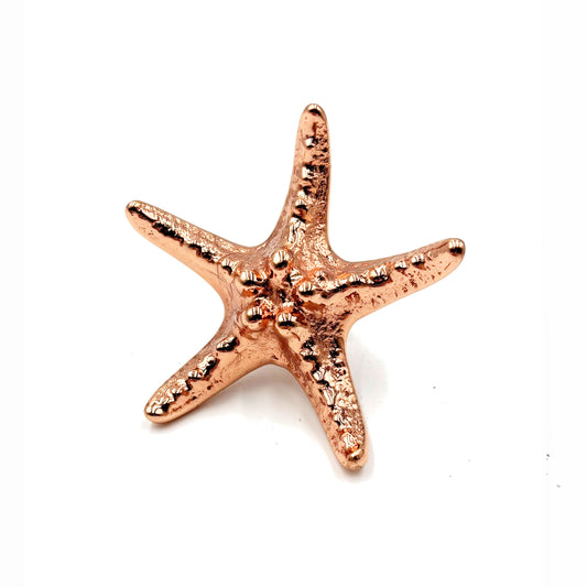 A petal copper colored startfish cabinet knob on a white background
