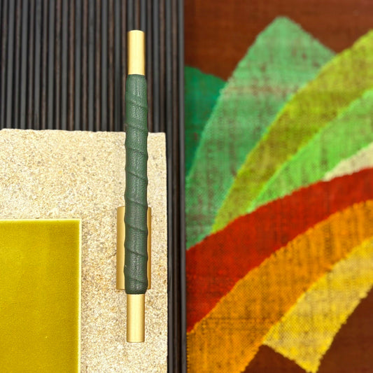 Dark Green Leather wraped counterbalaced tubular cabinet upull moodboard with stone and a handwoven textile background