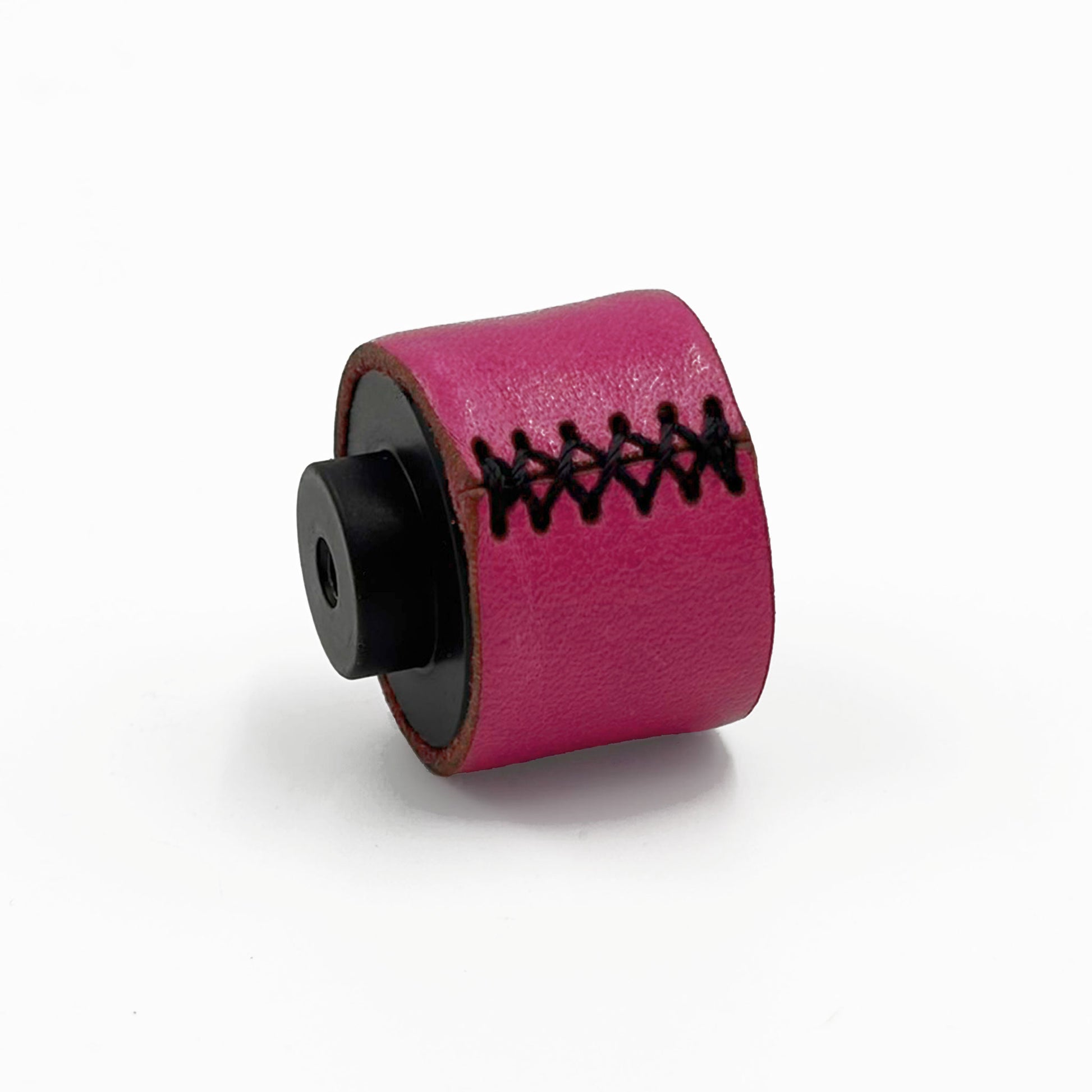 A small cylindrical pink leather cabinet knobs with black stitching and a black standoff, photographed on a clean white background.