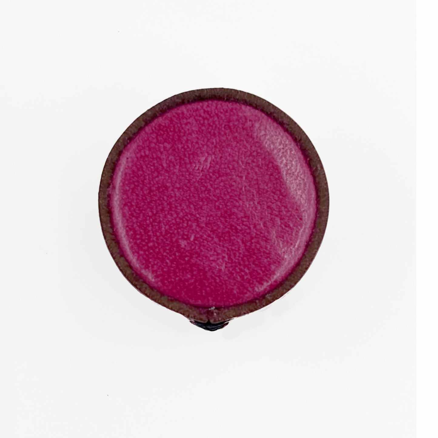 A single leather cabinet knob with a  magenta-pink center and a dark brown outer rim, shown against a plain white background.