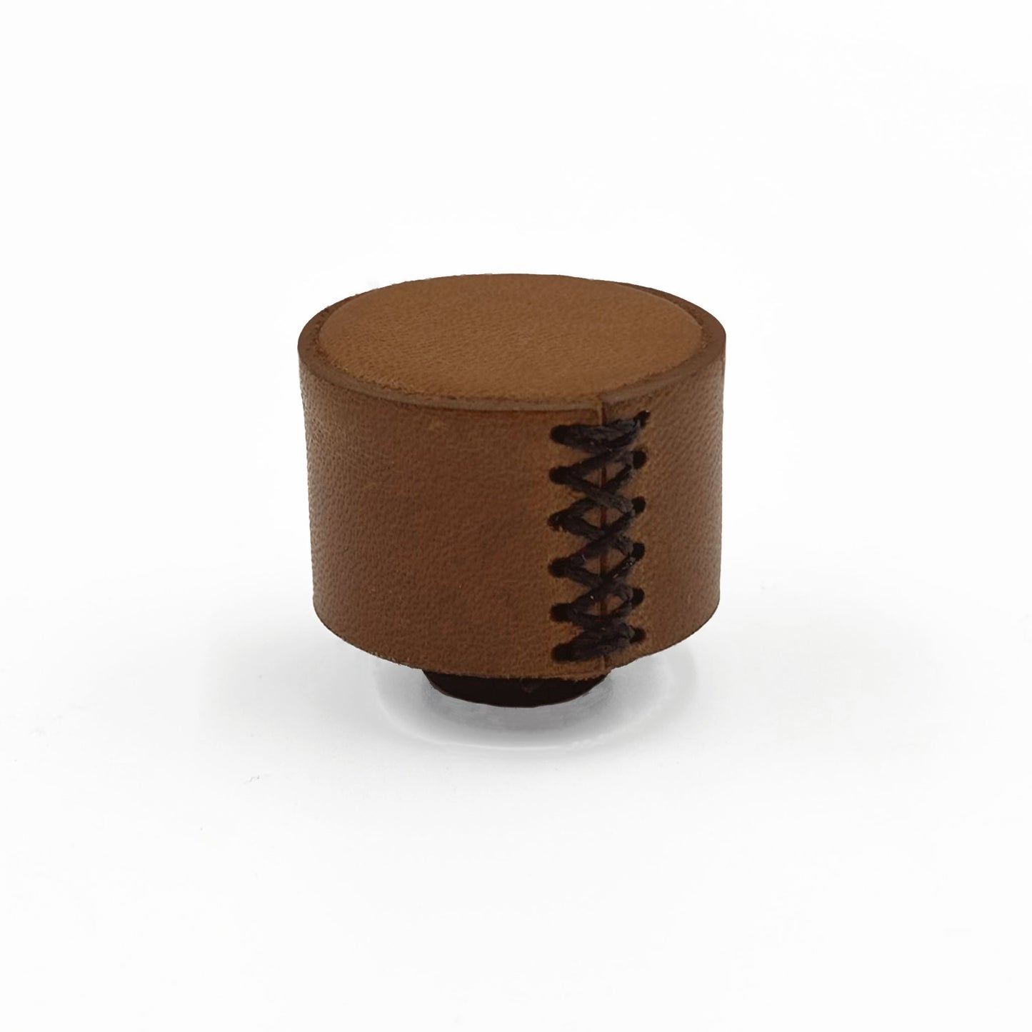 A brown leather cabinet knob with decorative black lacing on the side, photographed on a clean white background.