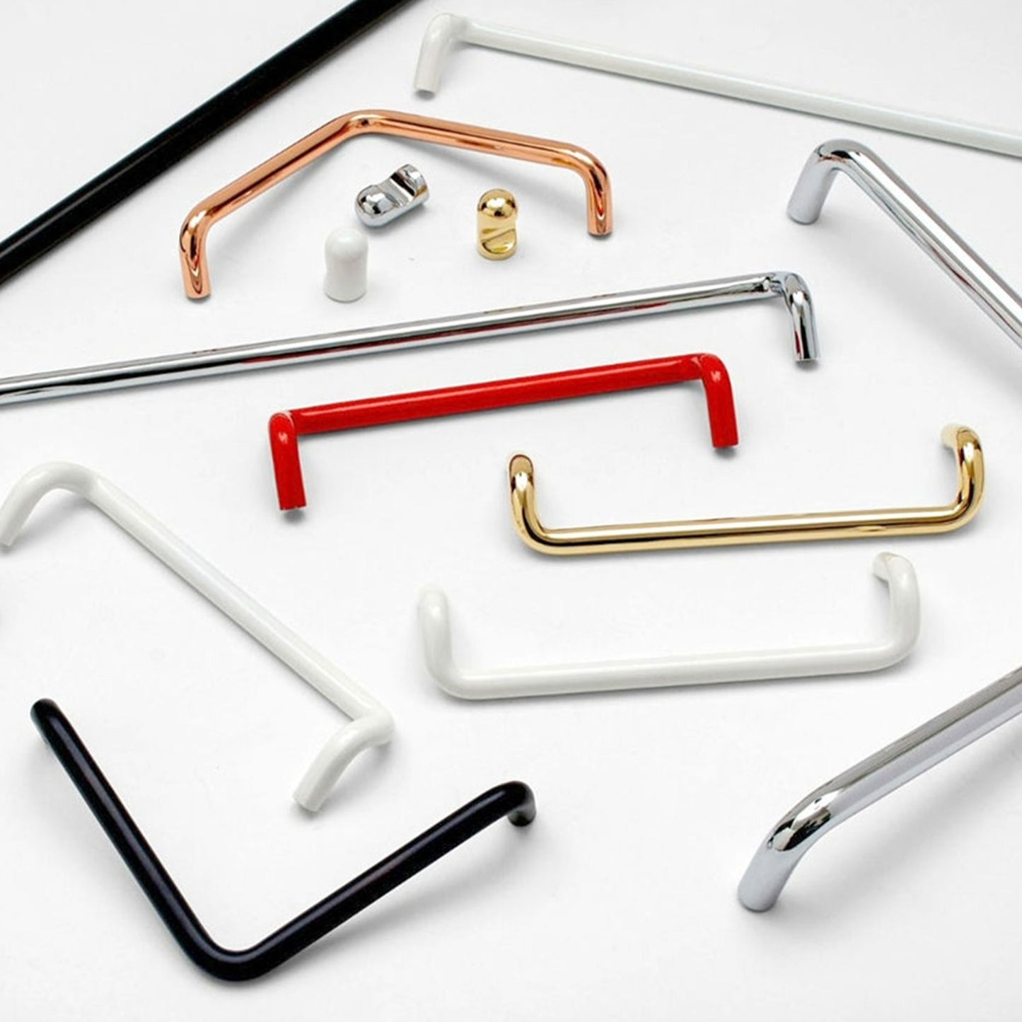 A set of modern cabinet handles in various finishes, including black, white, silver, gold, and red, arranged on a clean white background.