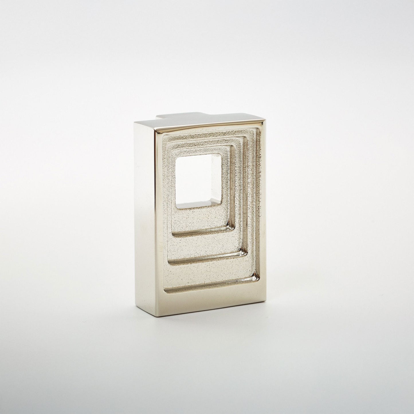 A modern rectangular cabinet pull with a textured metallic finish, featuring a square cutout design, shown on a clean white background.