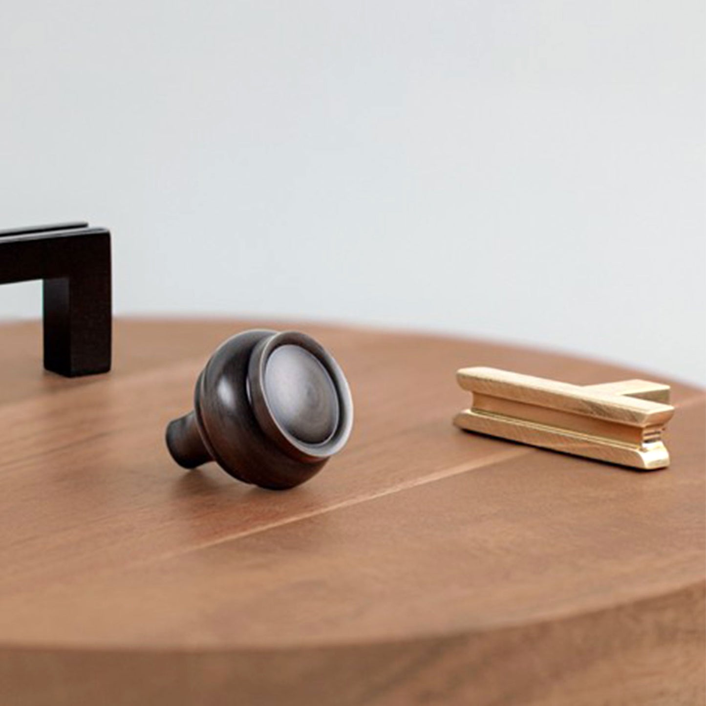 Granbury Collection cabinet knob, T-Pull and Pull on a wood background