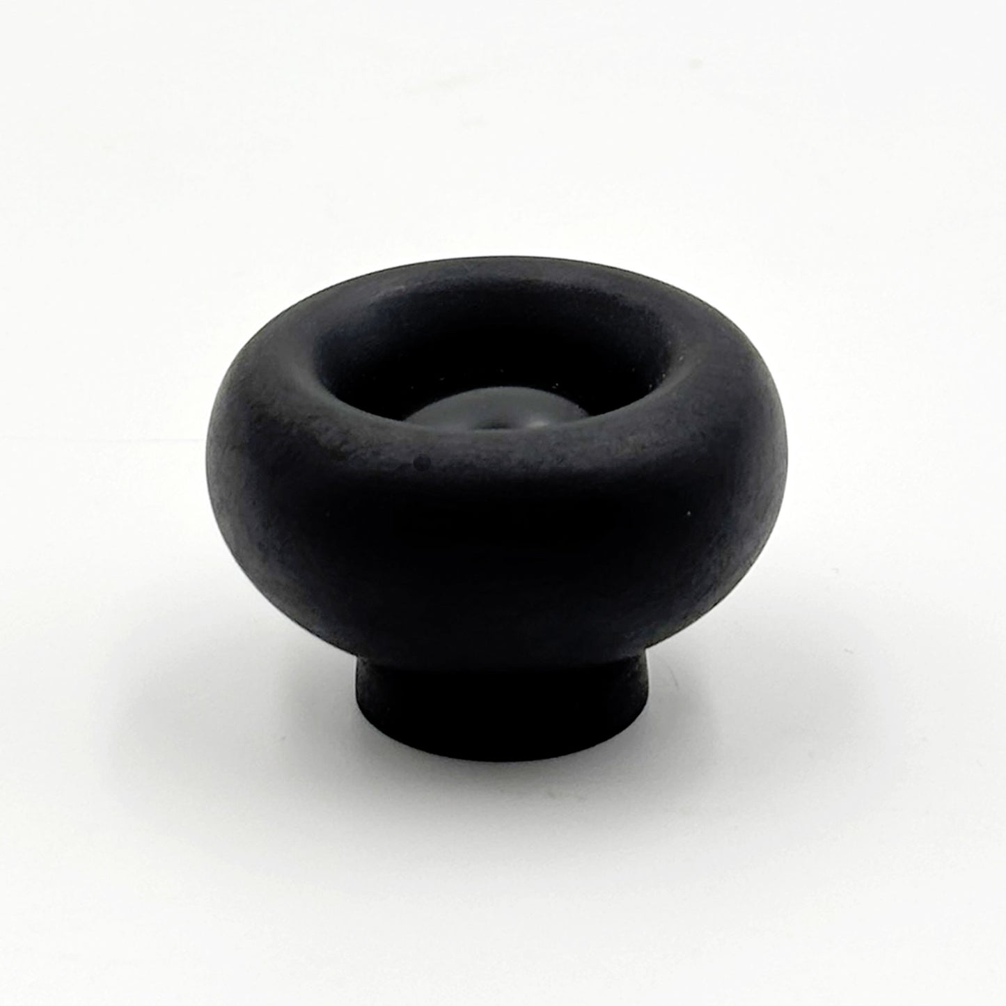 Chunky black colored cabinet knobs on a white background