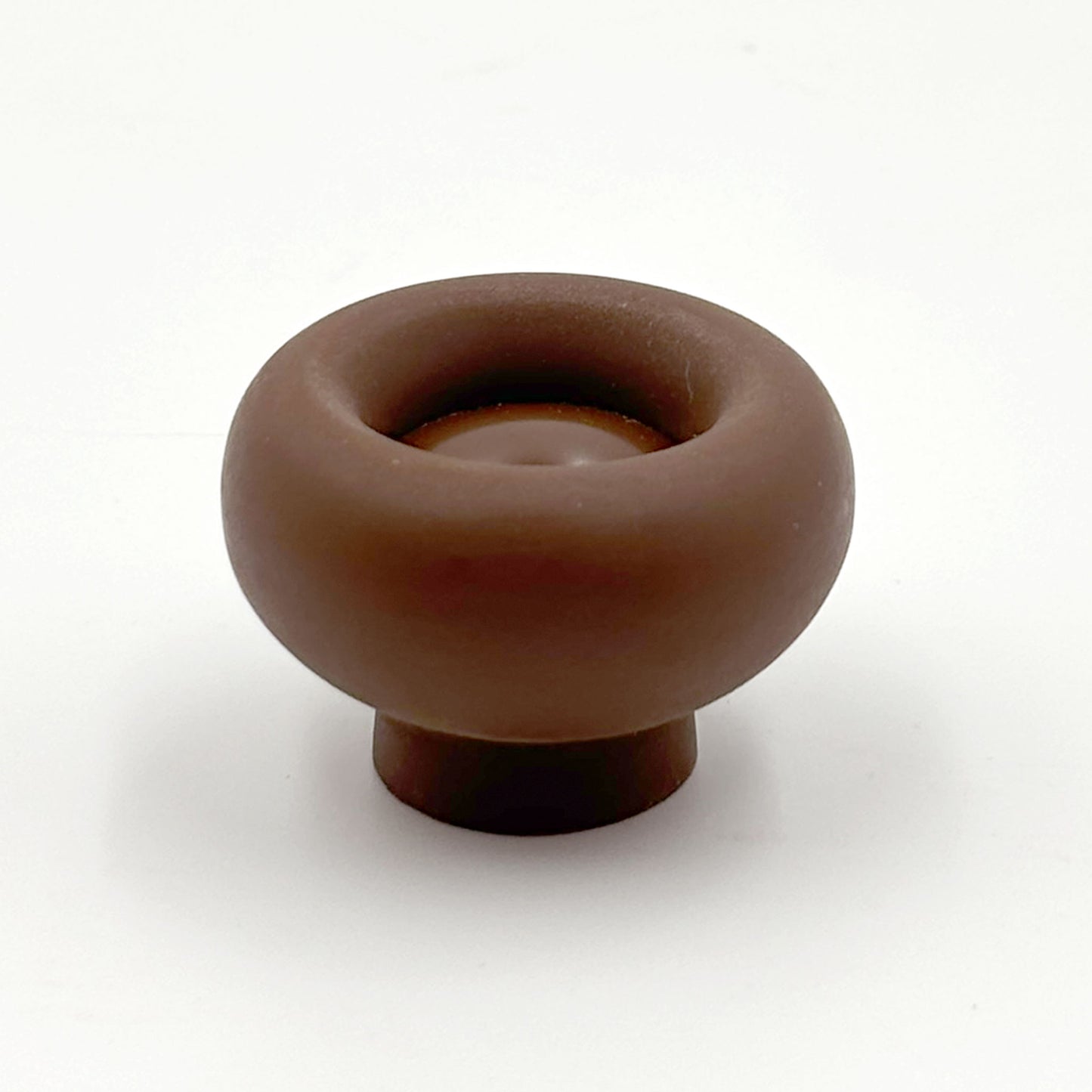 Chunky brown colored cabinet knobs on a white background