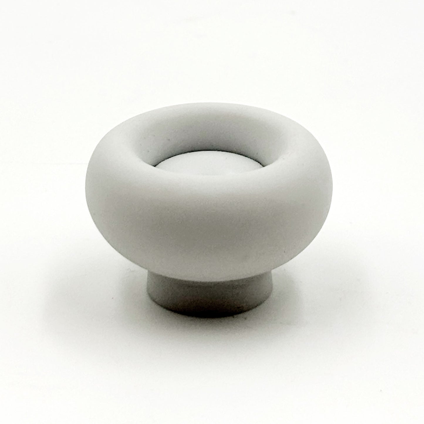 Chunky grey colored cabinet knobs on a white background