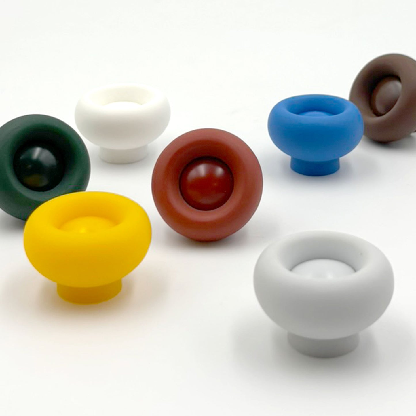 Set of colorful cabinet knobs on a white background