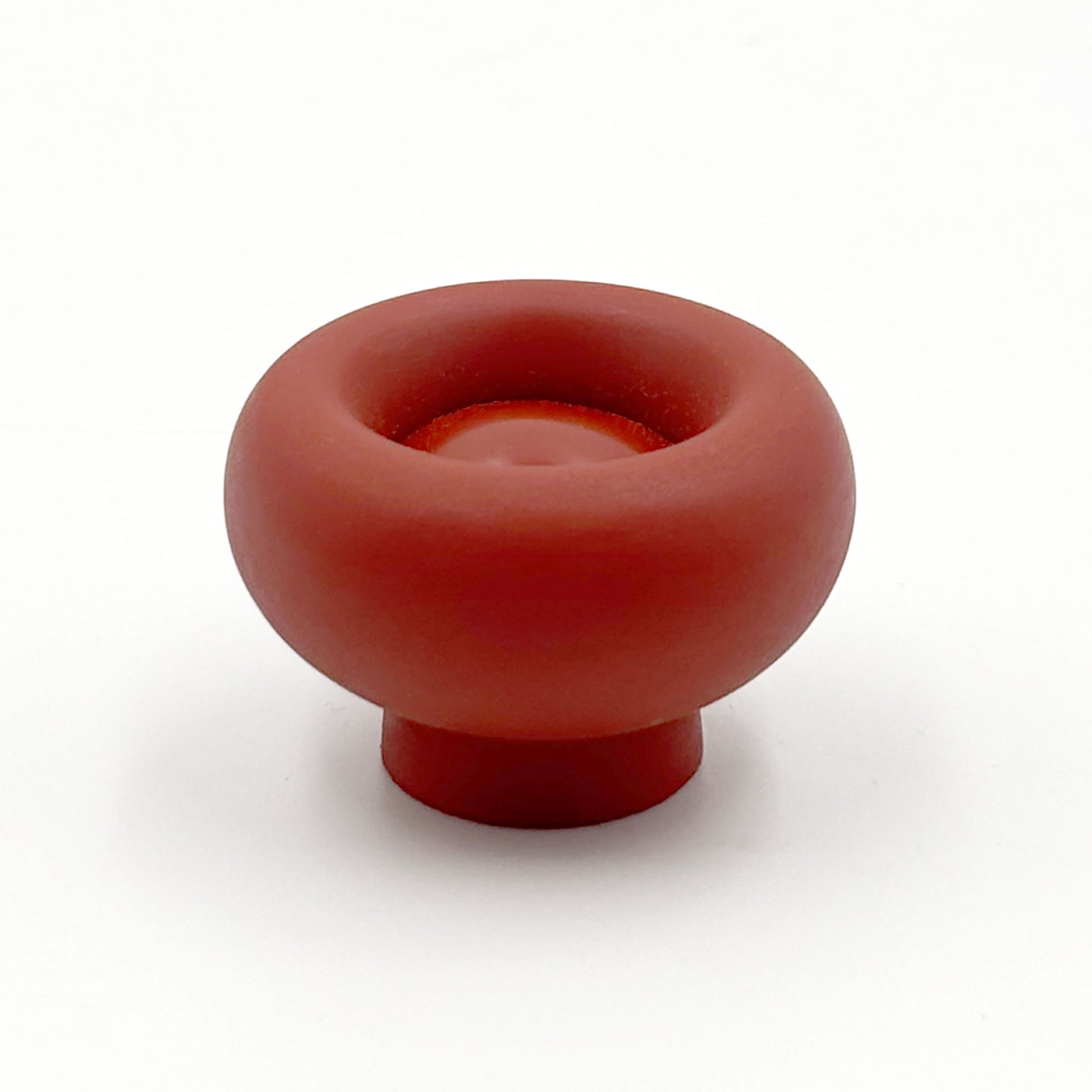 Chunky red colored cabinet knobs on a white background