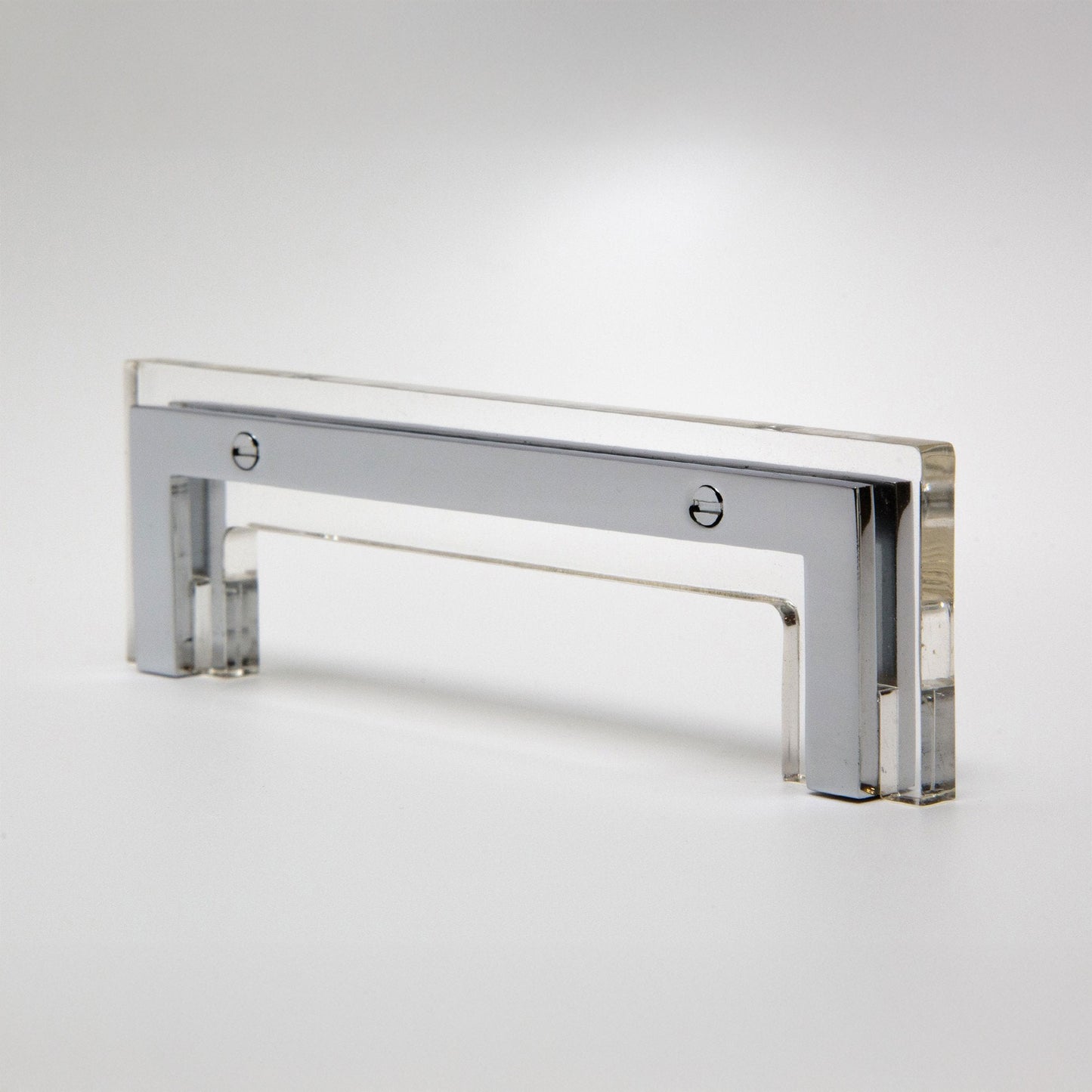 A modern rectangular acrylic cabinet pull handle with a polished chrome frame, shown on a clean white studio background.
