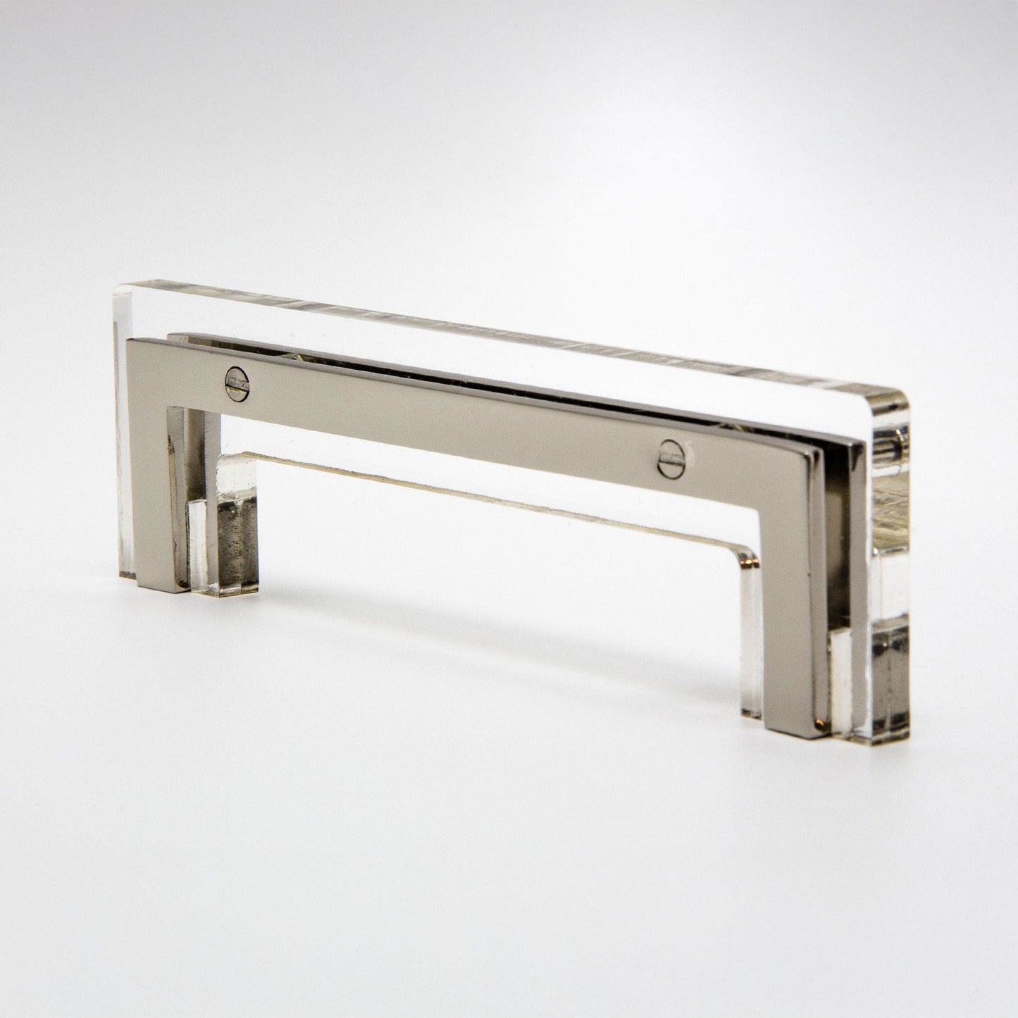 A modern rectangular cabinet pull handle made of polished silver-toned metal with a clear acrylic or glass front panel, shown on a clean white studio background.