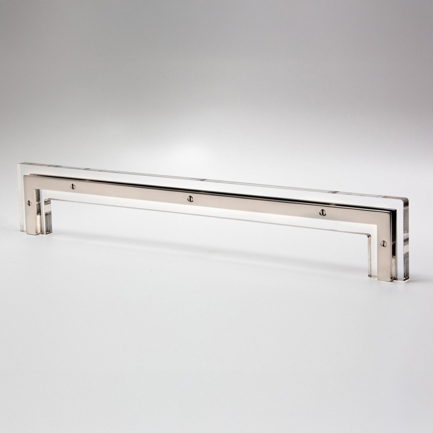 A long, slim polished metal cabinet pull with a reflective silver finish, photographed on a clean light gray studio background.
