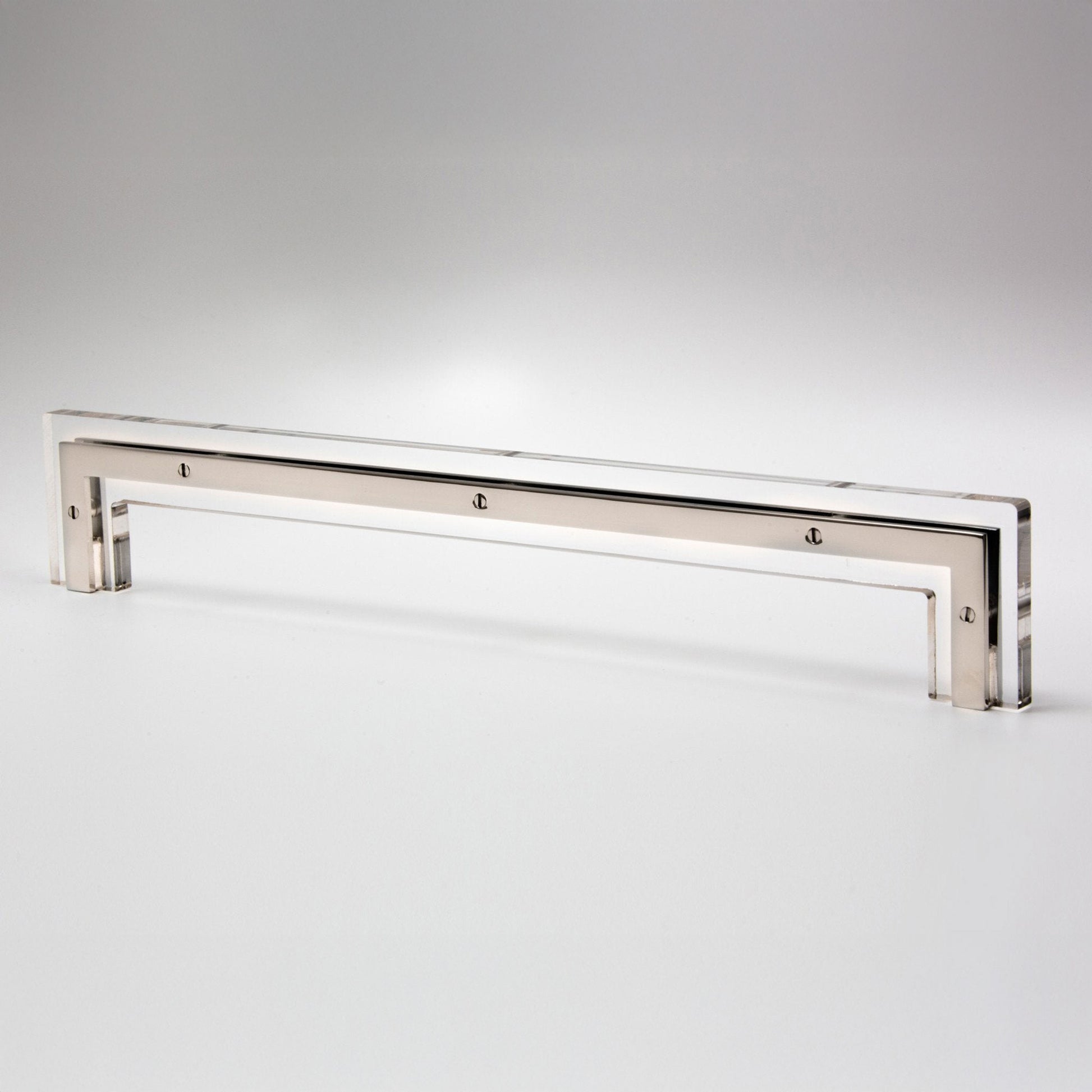 A long, slim polished metal cabinet pull with a reflective silver finish, photographed on a clean light gray studio background.