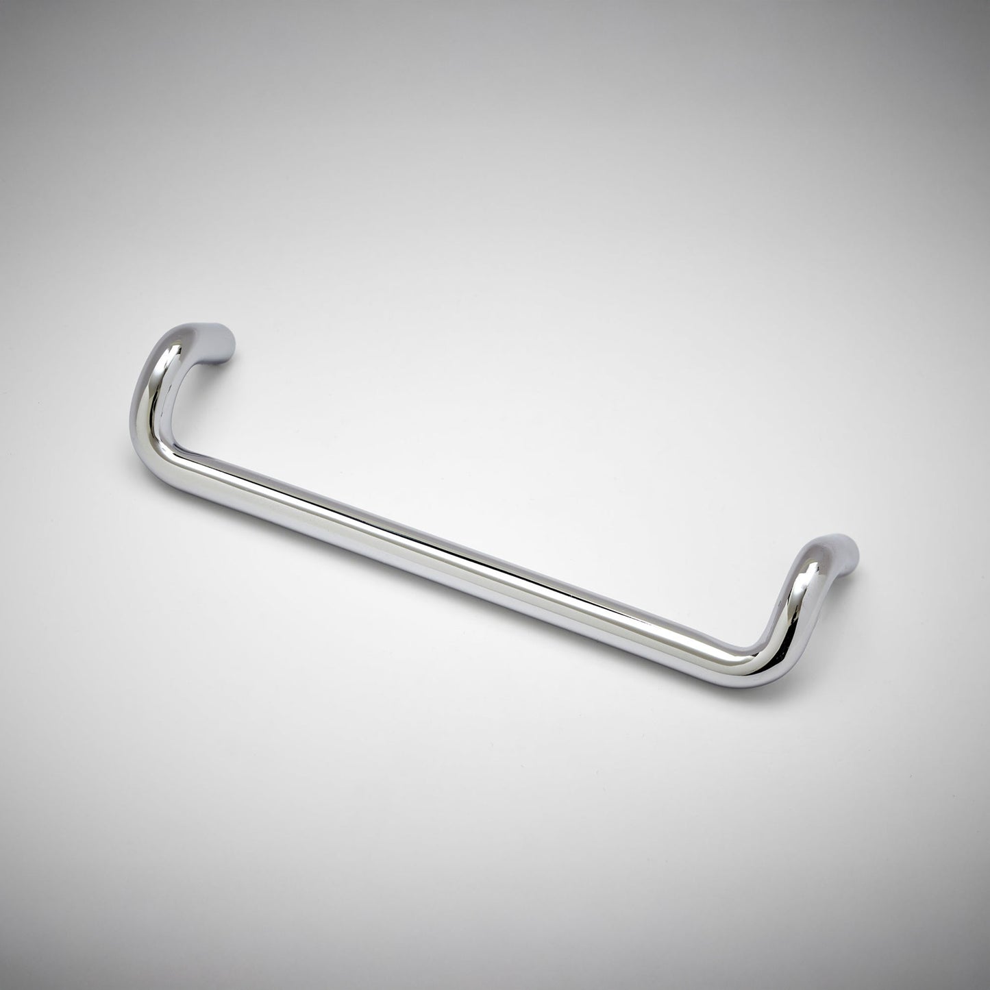 A chrome metal cabinet pull with a curved, U-shaped design, shown on a clean white background with a subtle vignette.