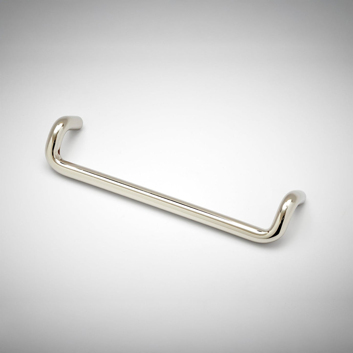 A polished nickel metal cabinet pull with a curved, U-shaped design, shown on a clean white background with a subtle vignette.