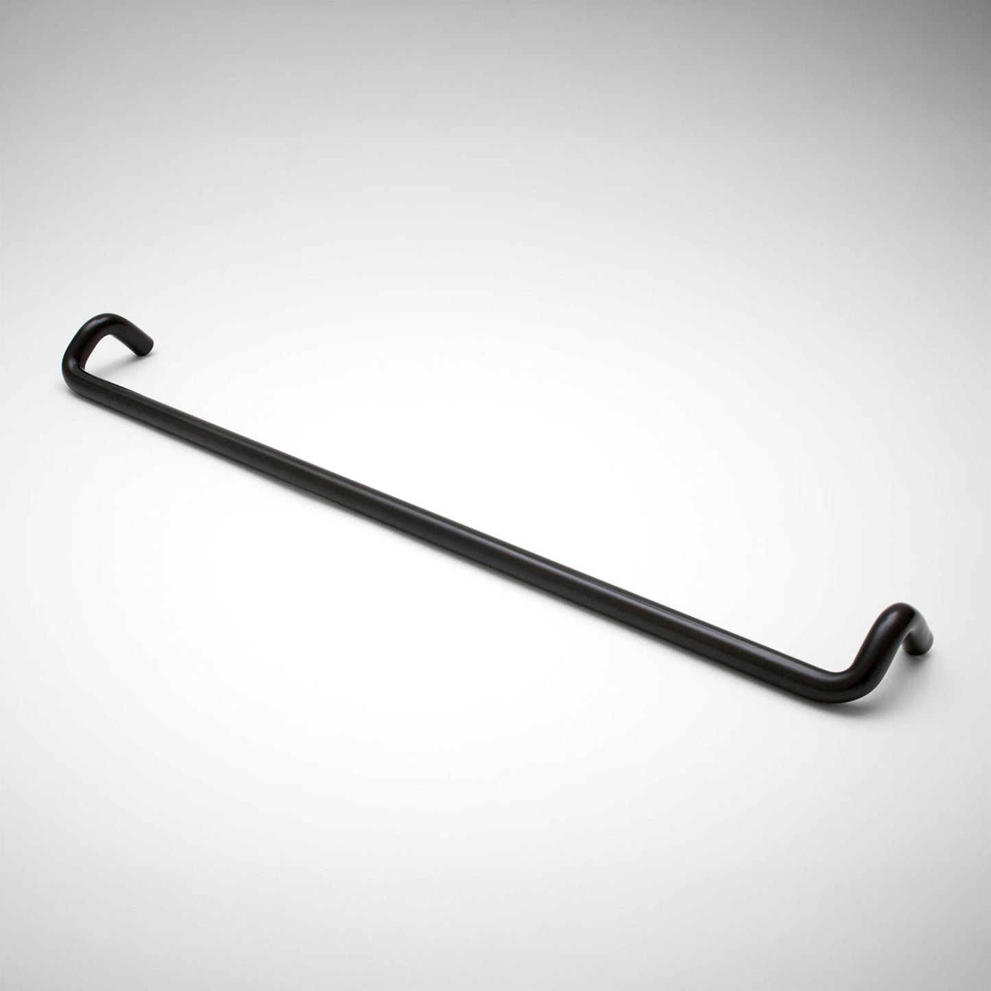 A cabinet pull with a sleek, curved design, shown diagonally on a light gray gradient background.
