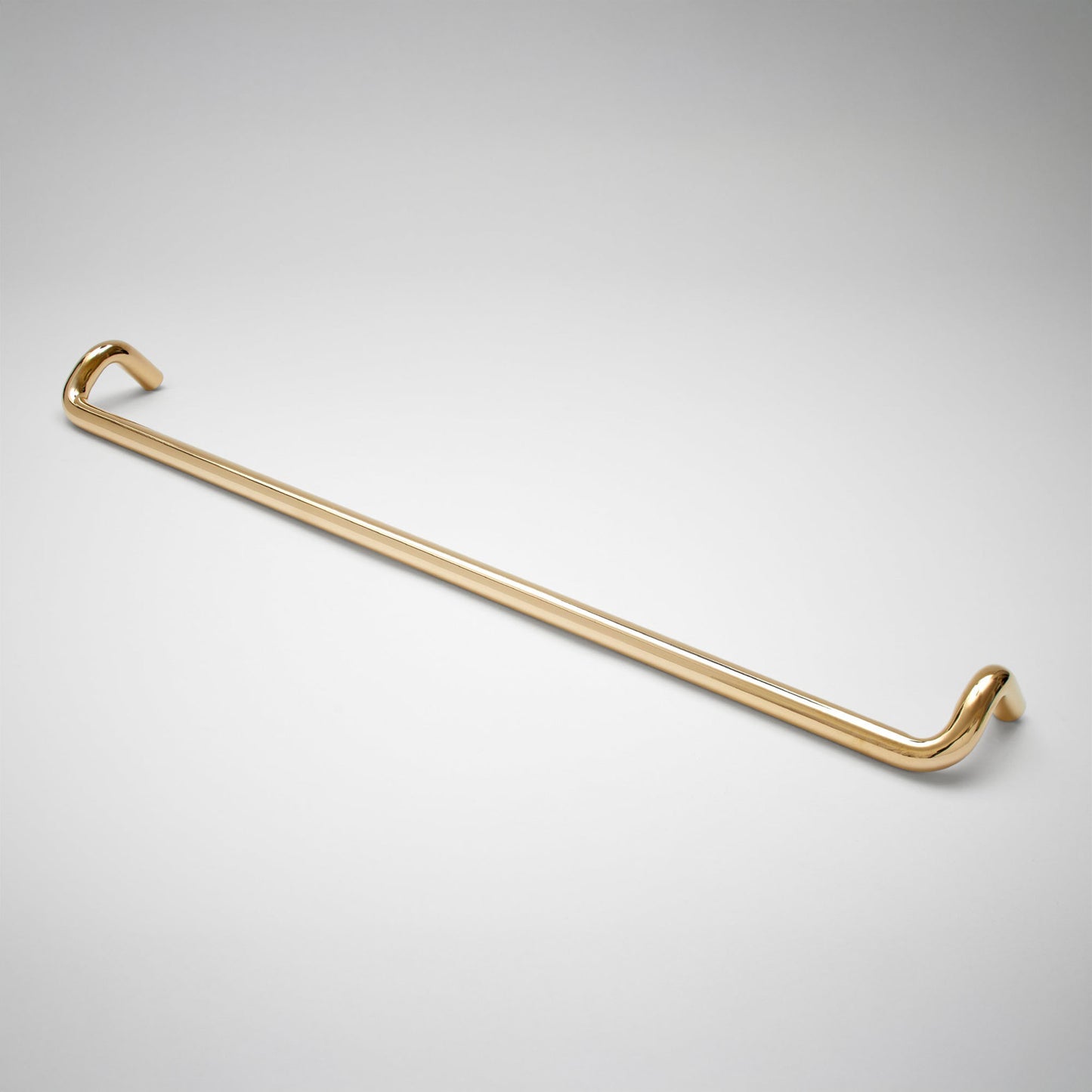 A polished cabinet pull with a sleek, curved design, shown diagonally on a light gray gradient background.