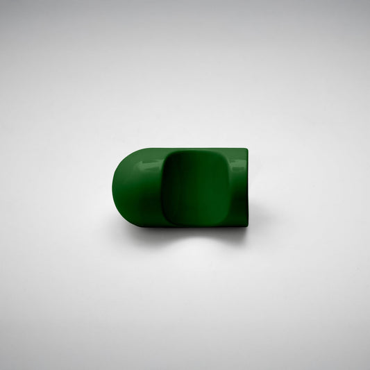 A glossy dark green cabinet pull with a rounded, modern dome-like shape, photographed on a neutral light gray background.