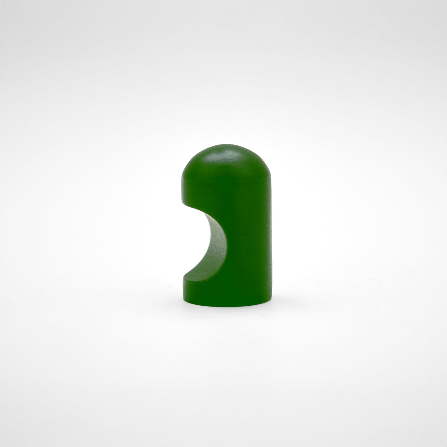 A glossy dark green cabinet pull with a rounded, modern dome-like shape, photographed on a neutral light gray background.